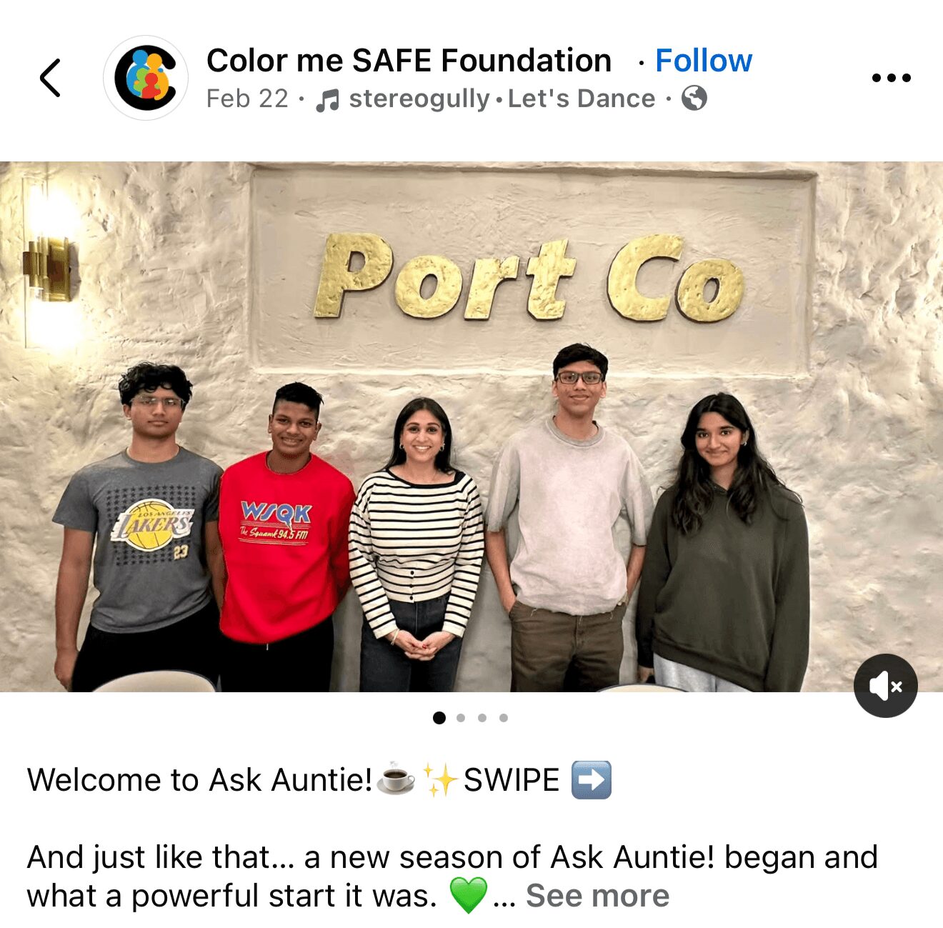 Five people standing in front of a wall with 'Port Co' sign, smiling, indoors.