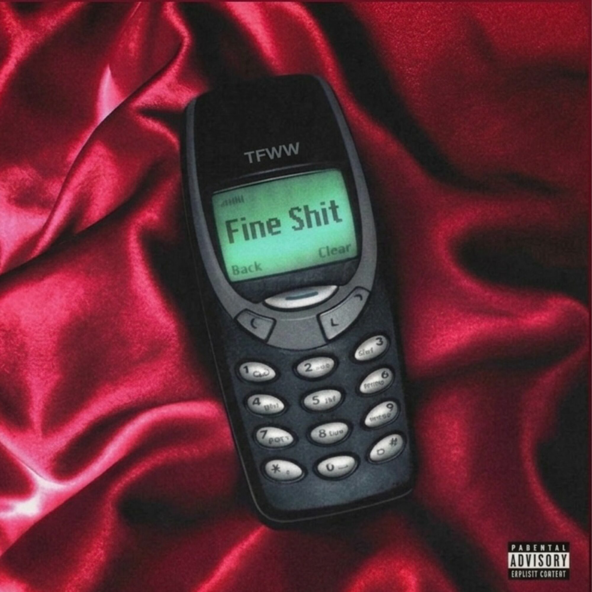 Old mobile phone with a screen displaying the words 'Fine Shit' on red satin fabric.