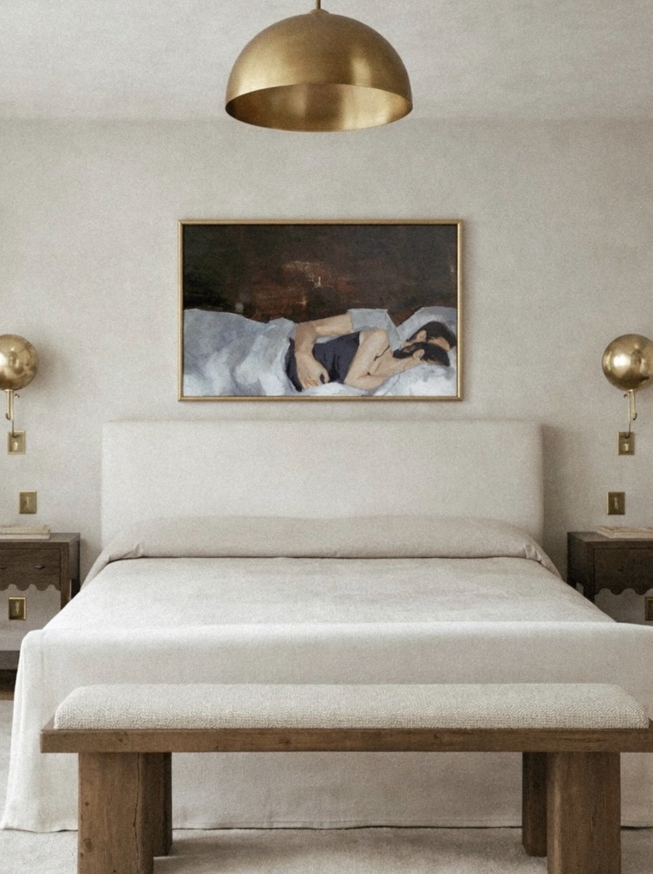 Bedroom with a bed, two nightstands, wall art, and a gold ceiling lamp.