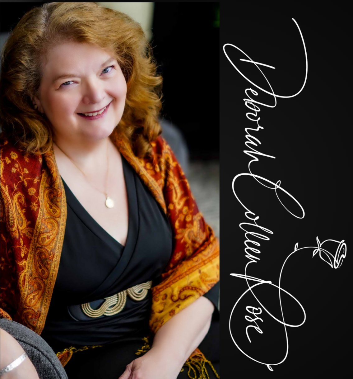 Woman with curly hair smiling, wearing a black top and orange patterned jacket, sitting indoors.