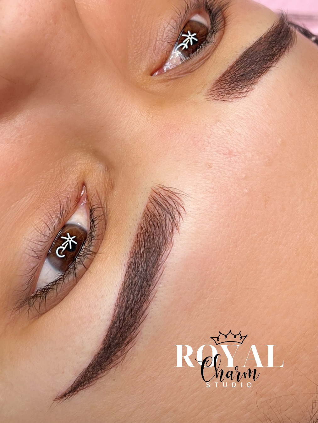 Close-up of eyes and eyebrows with makeup, showing well-groomed eyebrows and eye makeup.