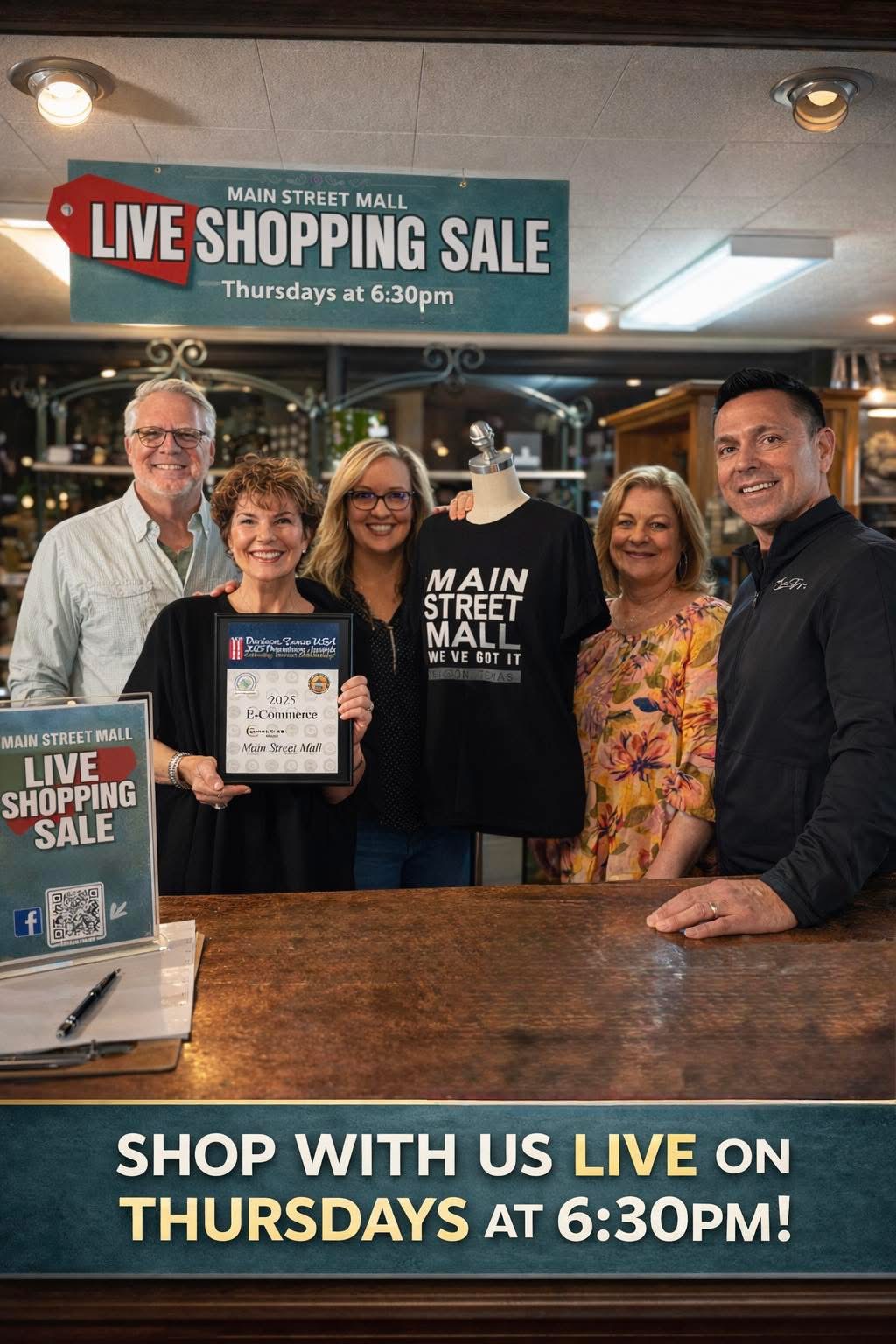 Group of five people standing behind a counter, holding a certificate, smiling, in a shopping mall during a sale event.