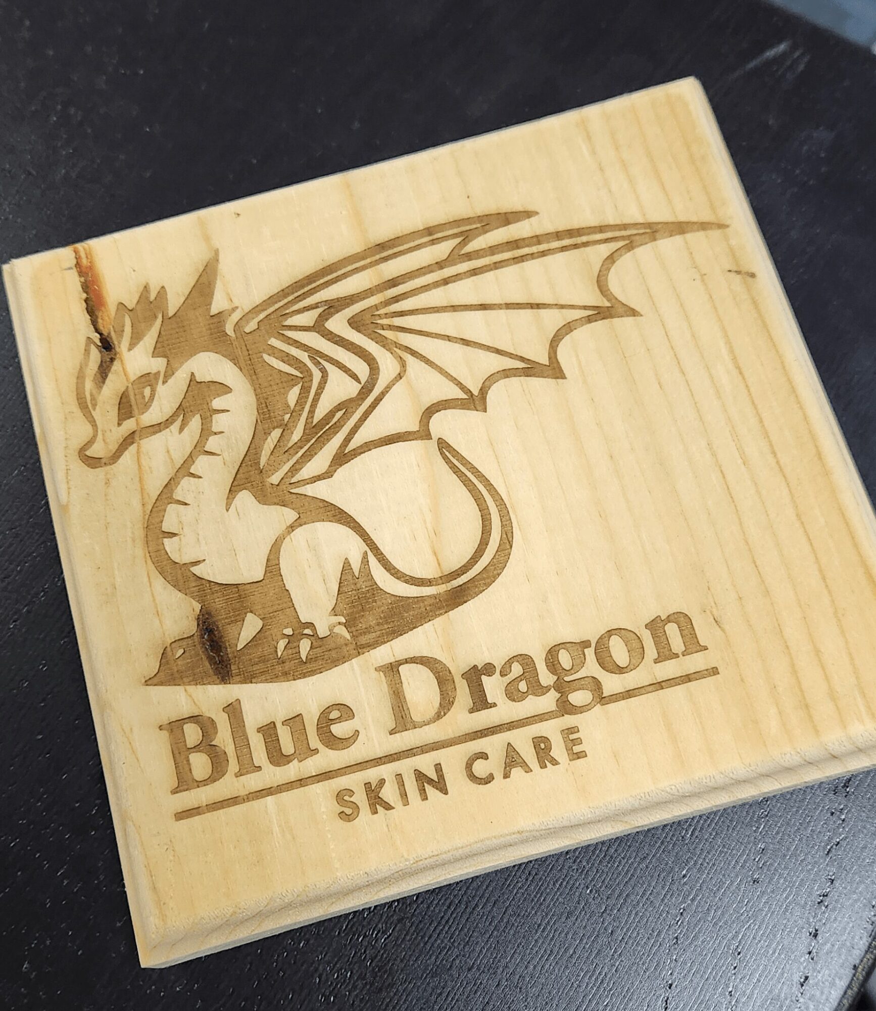 Wooden box with a dragon illustration and text reading 'Blue Dragon SKIN CARE'.