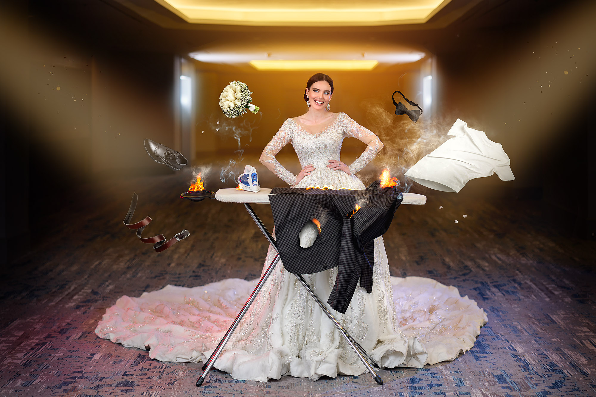 Woman in wedding dress standing behind an ironing board with flying clothes and objects around her.