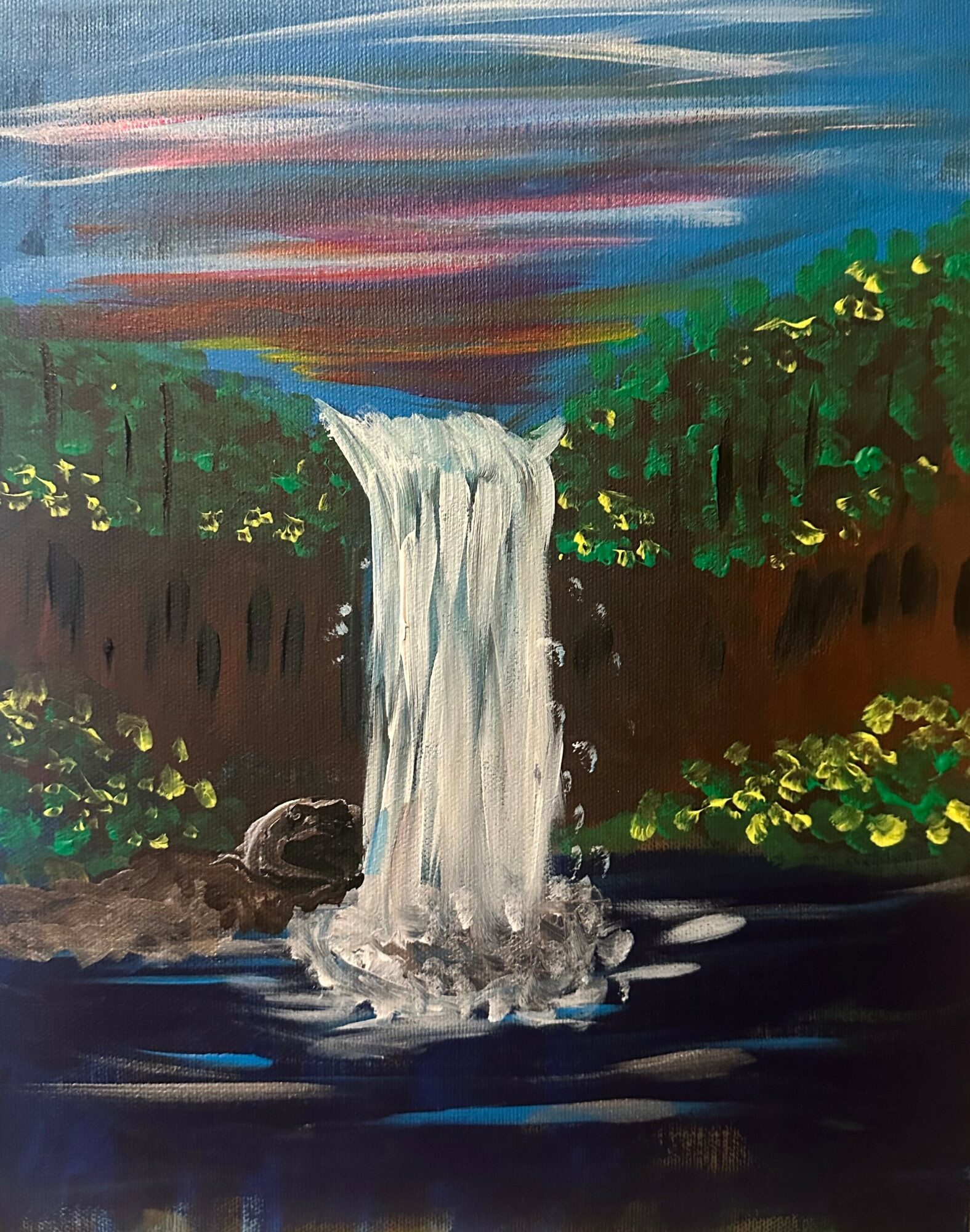 Waterfall flowing into a dark river, surrounded by green trees and a colorful sky with clouds.
