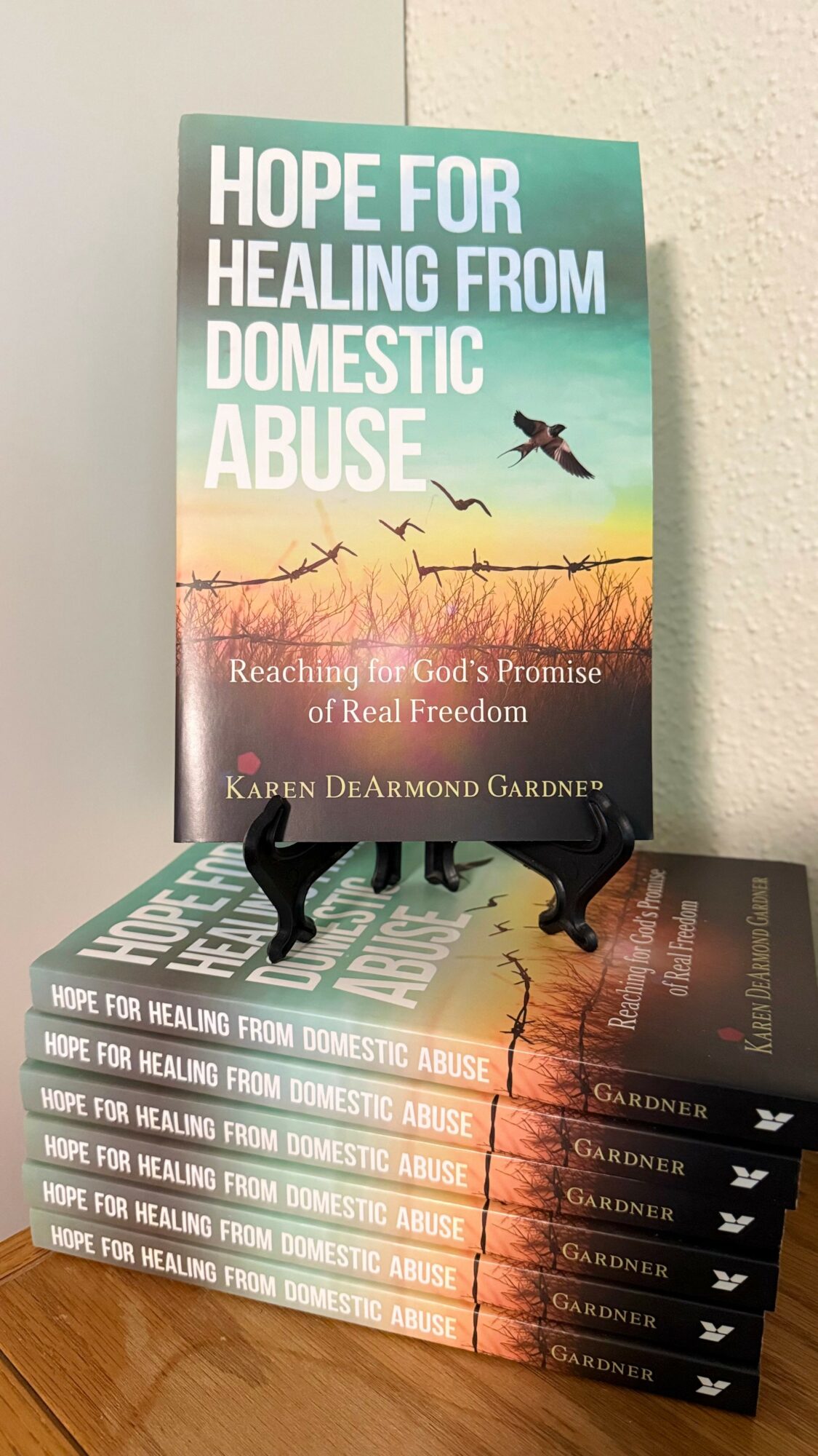 Stack of books with the top book titled 'Hope for Healing from Domestic Abuse' and a bird flying on the cover.