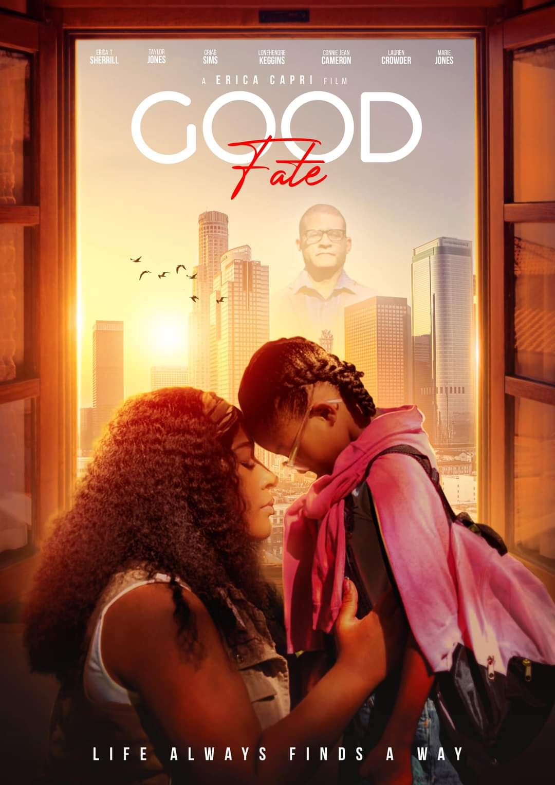 Two women face each other with foreheads touching, in front of a city skyline at sunset, with a man in glasses in the background.