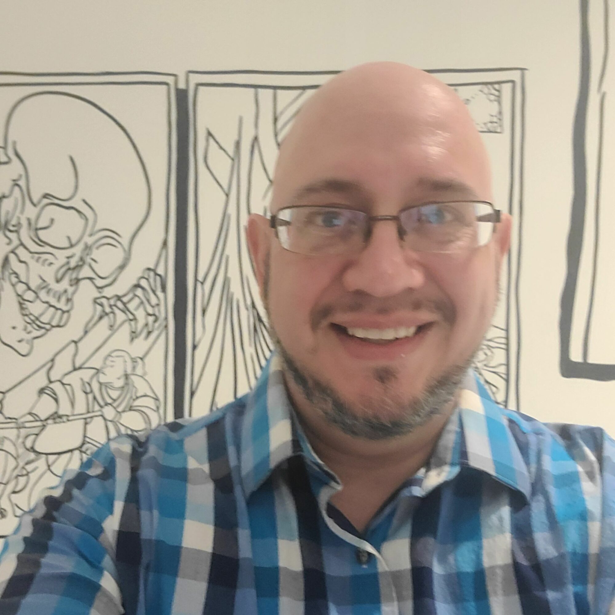 Man with glasses smiling, wearing a blue checkered shirt, in front of a comic-style drawing background.