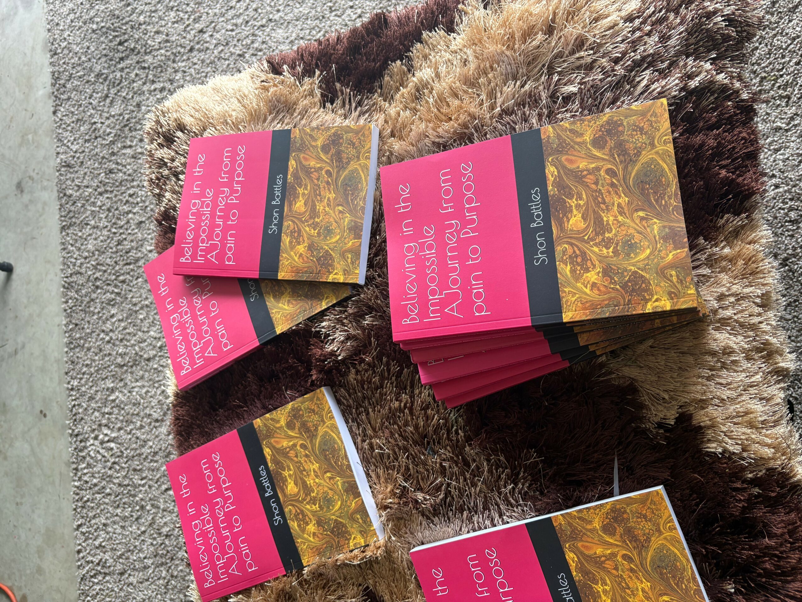 Stack of cards with pink and black text on a fuzzy surface, some cards are fanned out.