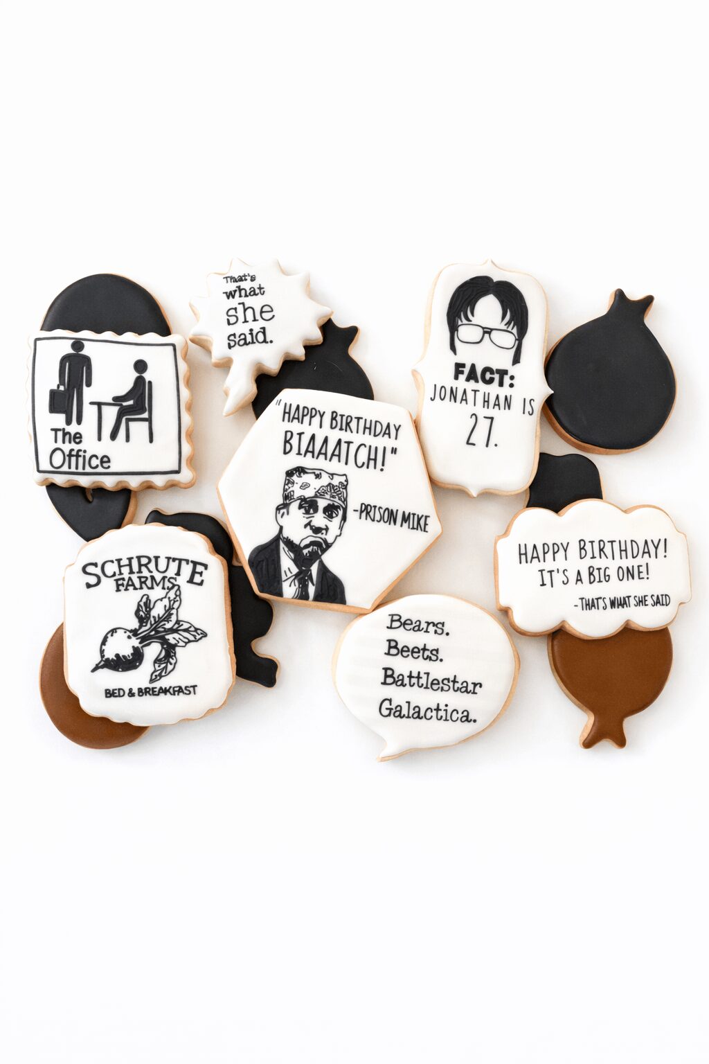 Collection of decorated cookies with office, birthday, and character themes, some with text and images, on a white background.