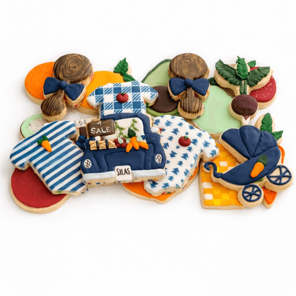 Colorful assortment of fabric toys including children with bows, a stroller, and various patterned clothing items on a white background.