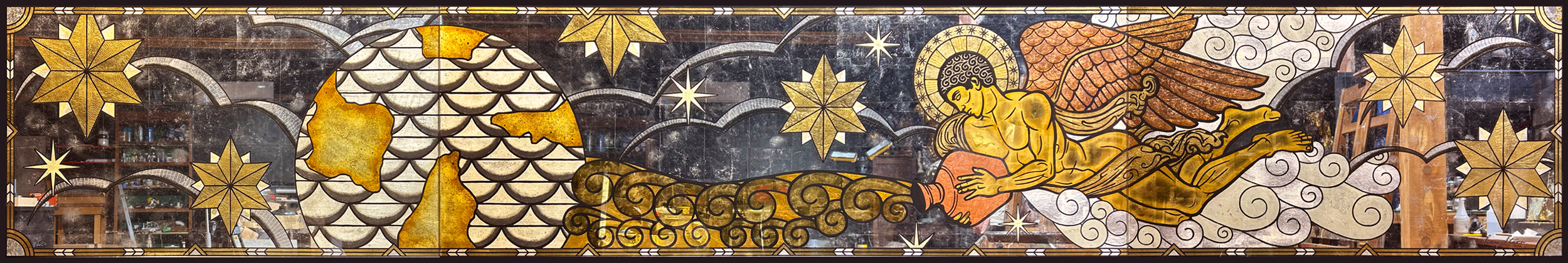 Decorative horizontal pattern with gold, silver, and black elements, including clouds, flowers, and abstract shapes.