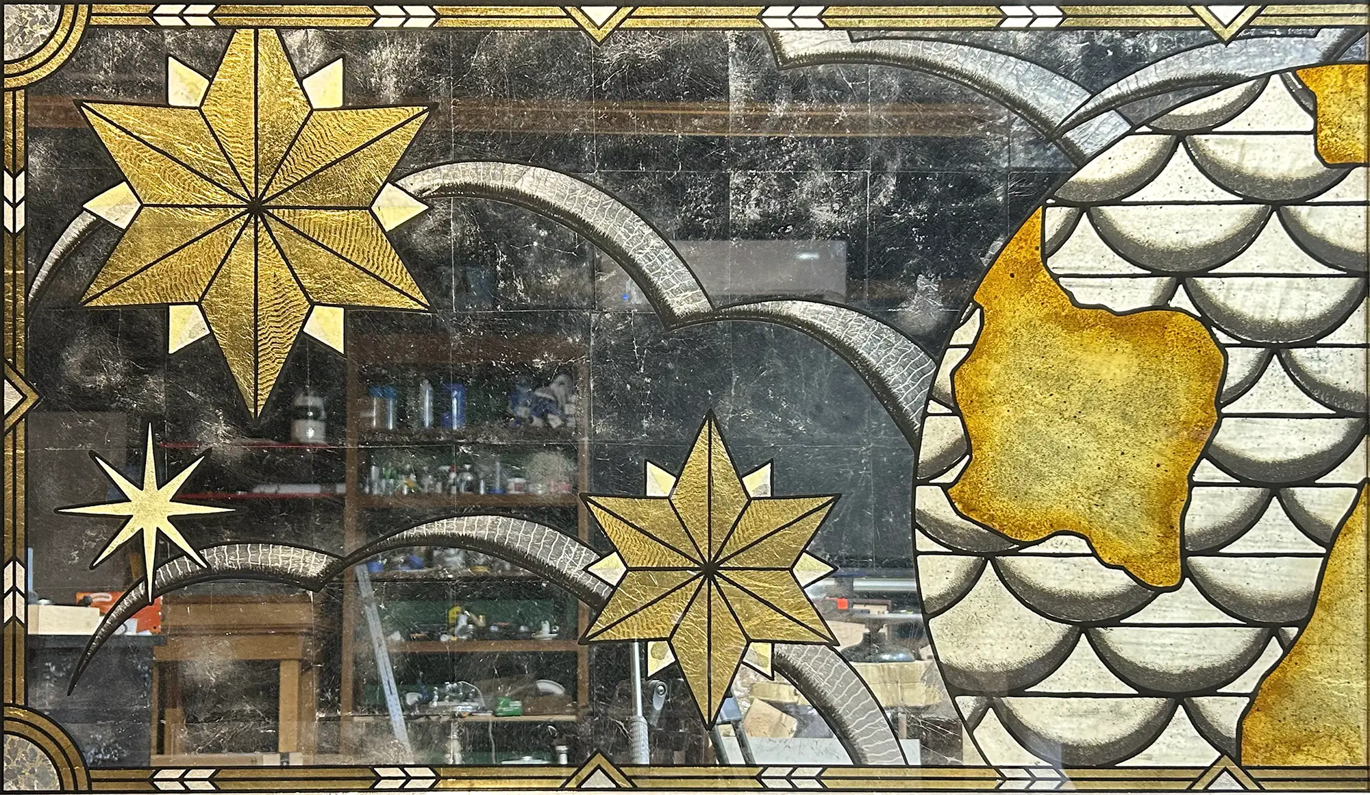 Decorative stained glass window with star shapes and abstract patterns, featuring yellow, black, and white colors.