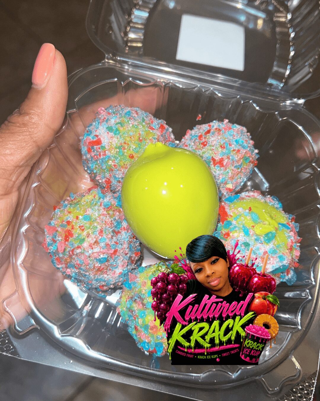 Hand holding a clear container with colorful sprinkled cake pops and a yellow egg-shaped object, with a photo sticker of a woman and text on the container.