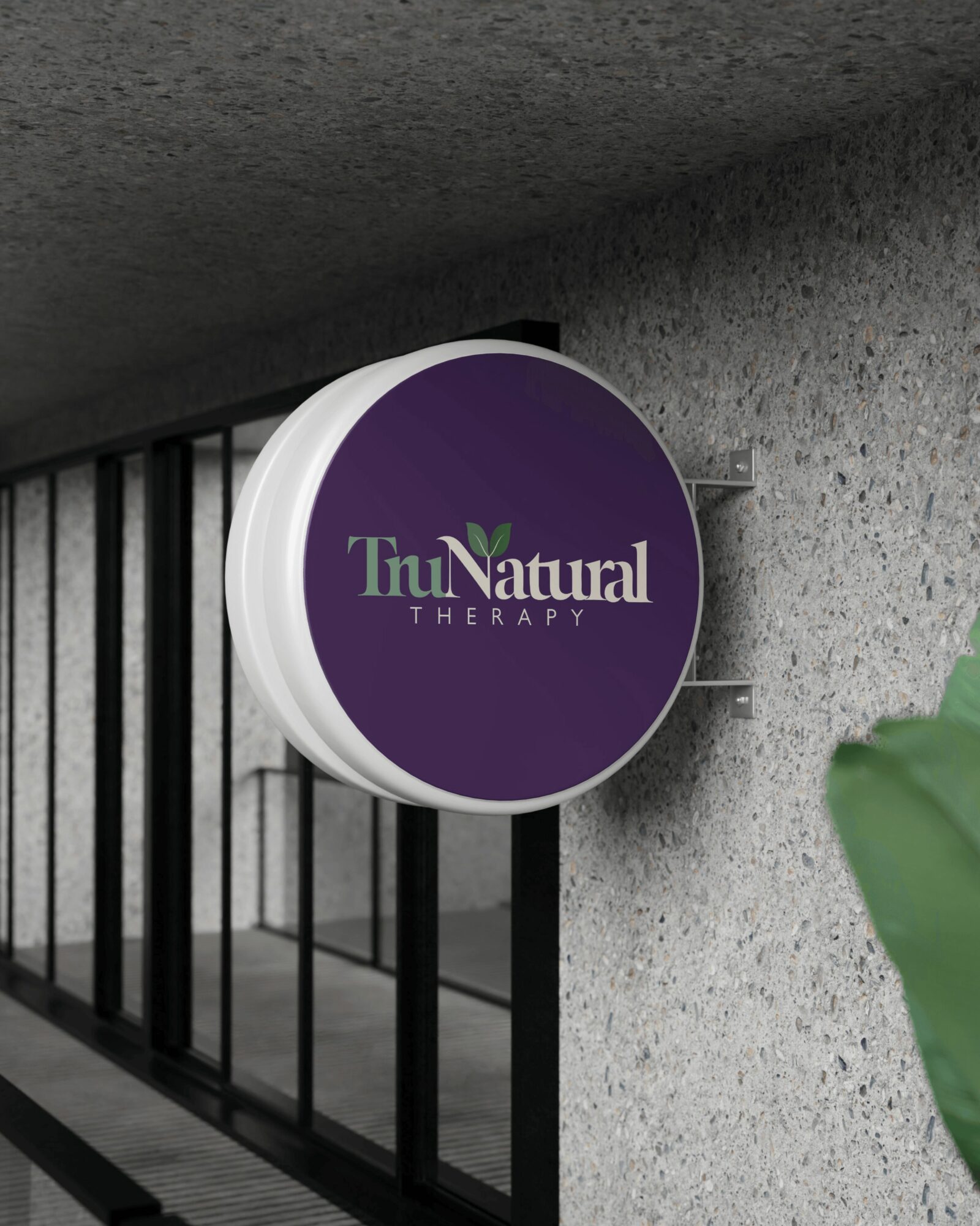Round sign with purple background and white text reading 