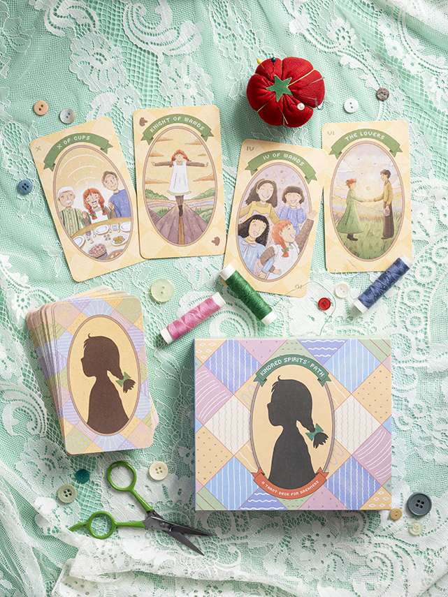 Four illustrated cards with women and children, sewing supplies, a red pin cushion, and a box with a silhouette, on lace fabric.