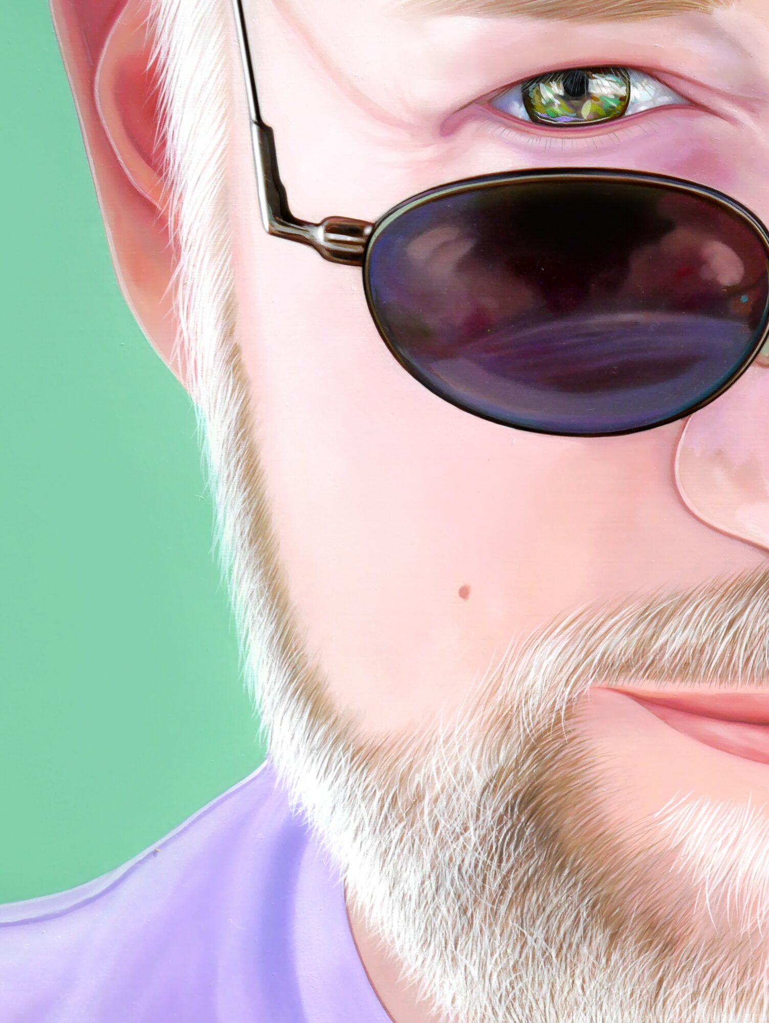 Close-up of a person with sunglasses, visible eye, beard, and part of face, against a green background.