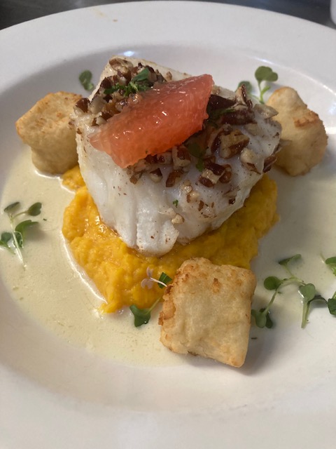Dish with fried tofu, scrambled eggs, watermelon, and microgreens on a white plate.