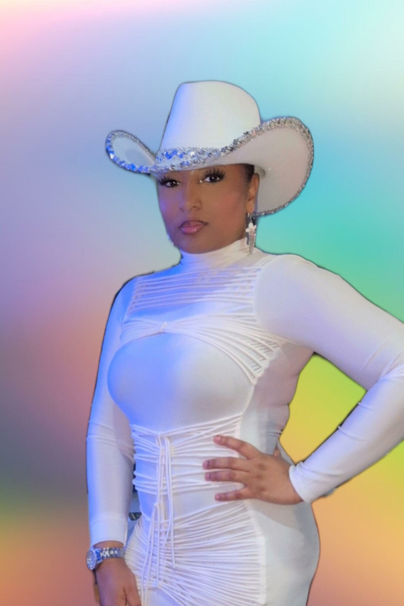 Woman in white cowboy hat and fitted dress poses with hand on hip against colorful gradient background.