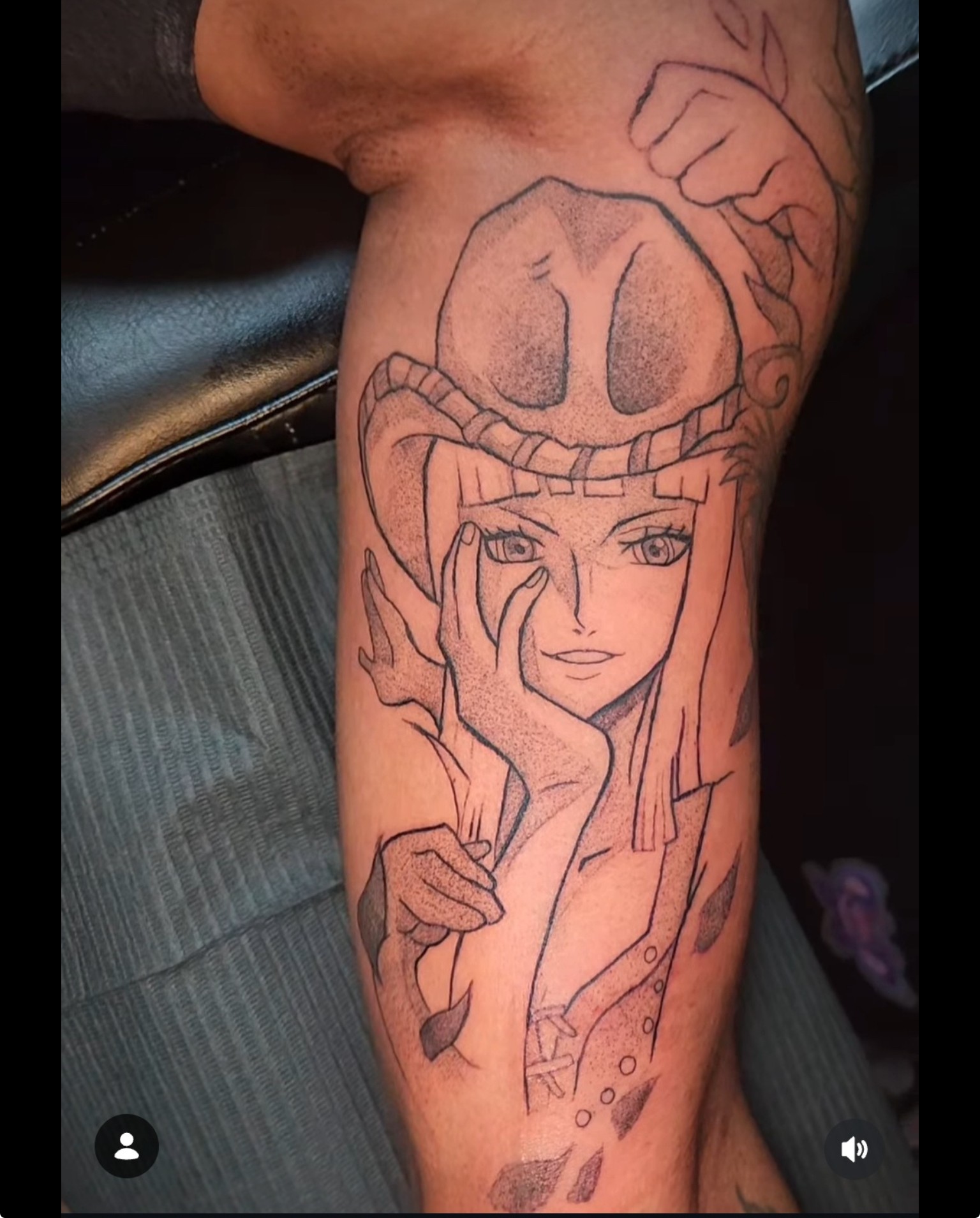 Line drawing tattoo of a woman with long hair, wearing a hat, resting her chin on her hand, on a person's arm.