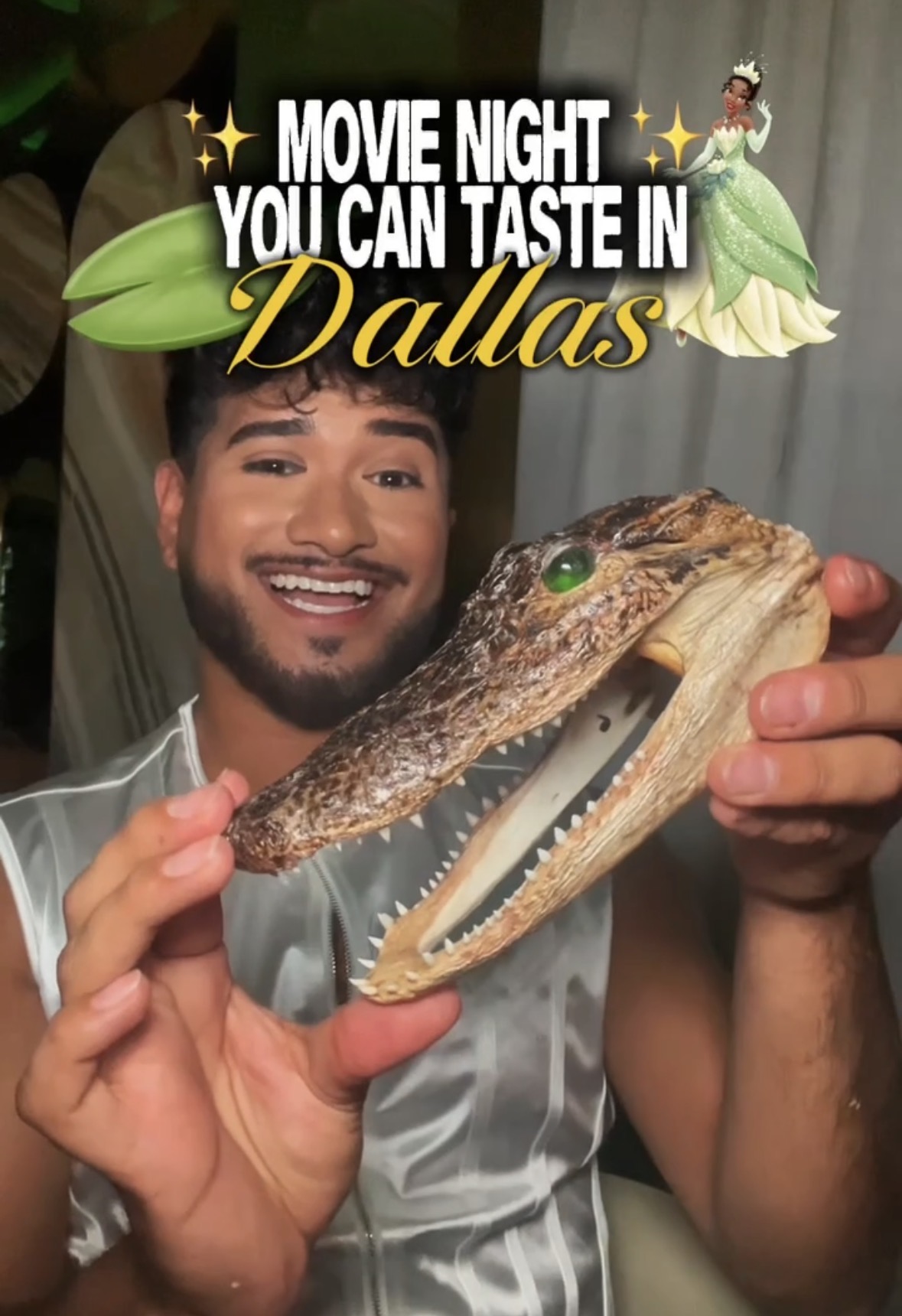 Man smiling holding a crocodile head with an open mouth, with text about movie night in Dallas, decorated with Disney princesses.