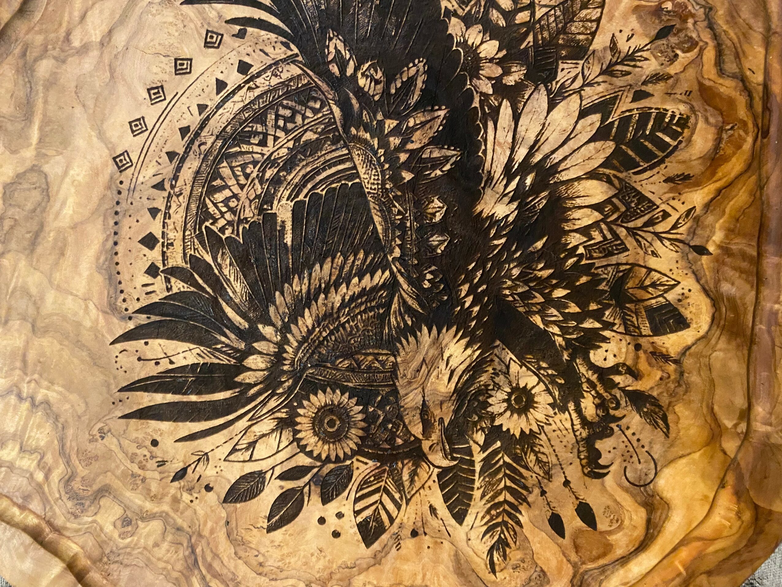 Black and white butterfly with detailed wings surrounded by floral and geometric patterns on textured background.
