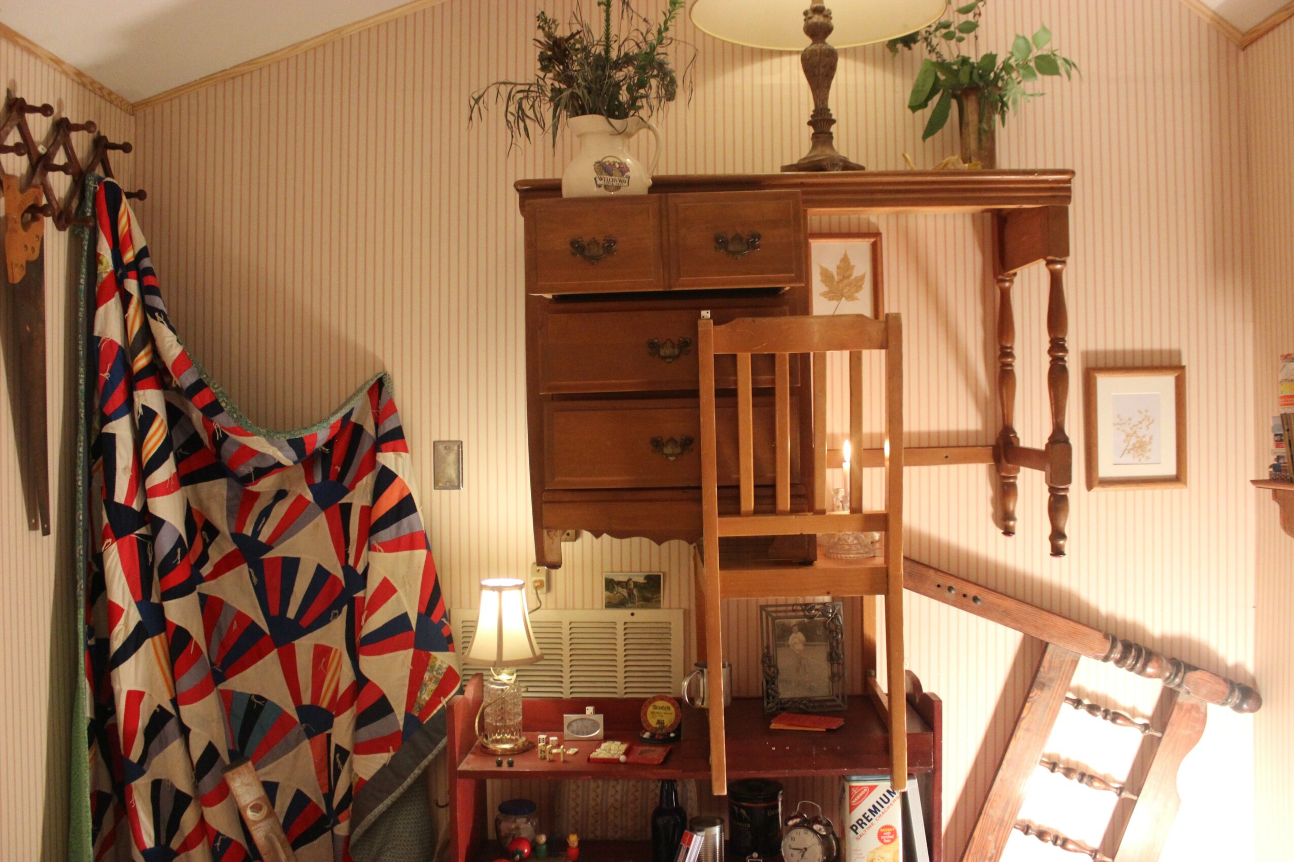 Living room with wooden furniture, a patterned chair, and a lamp, viewed from below. Word count: 20.