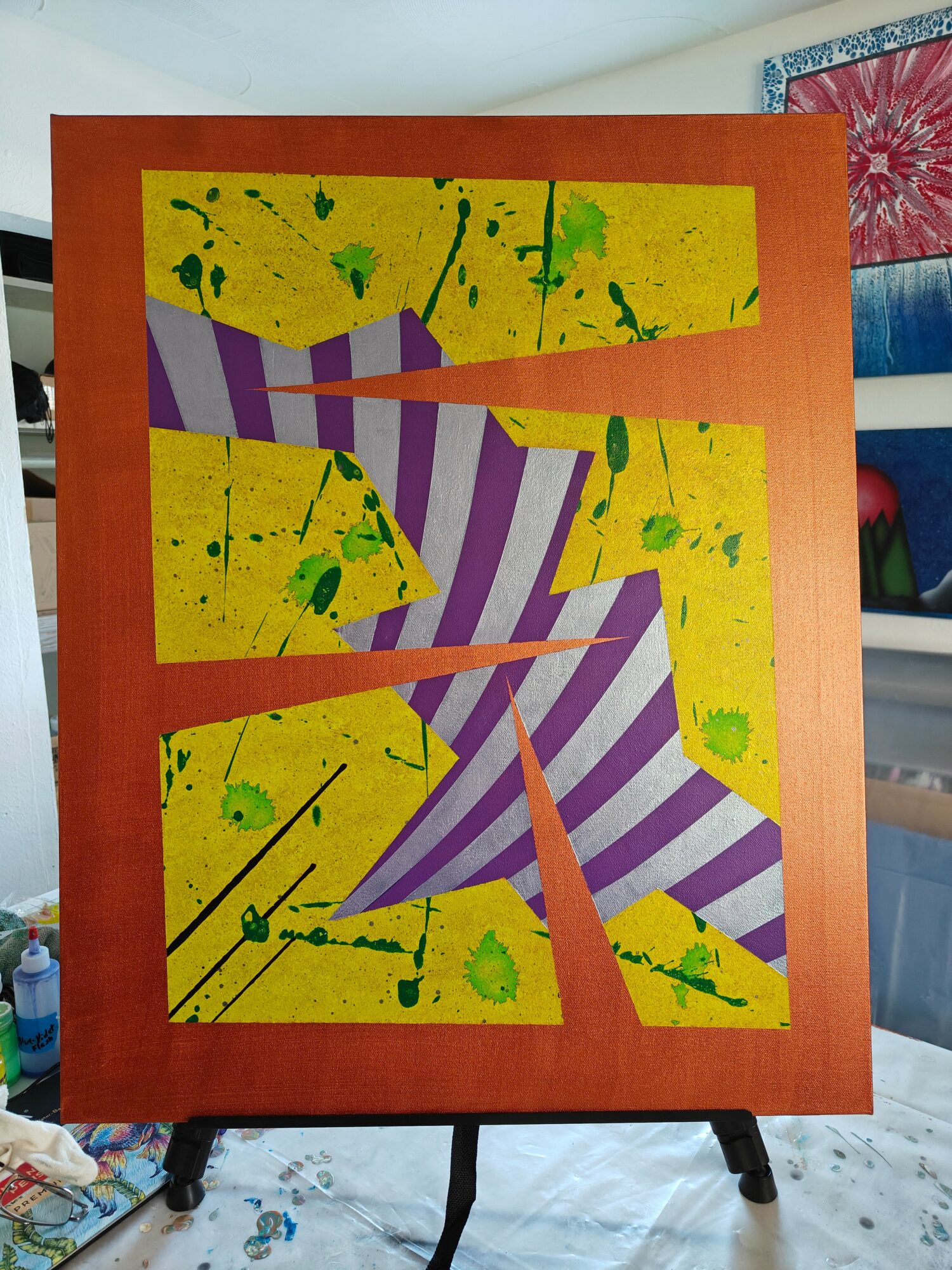 Abstract painting with purple and white striped shapes on a yellow background with green splatters, framed in brown.