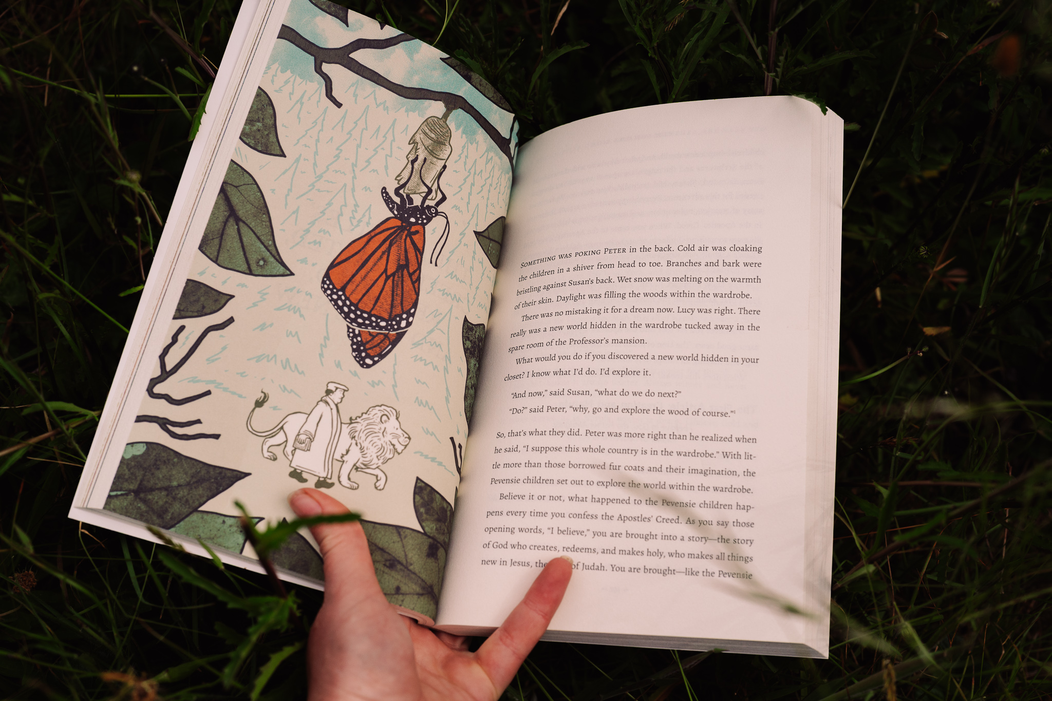 Open book showing an illustration of a girl in a red dress and a white dog, with text on the opposite page.