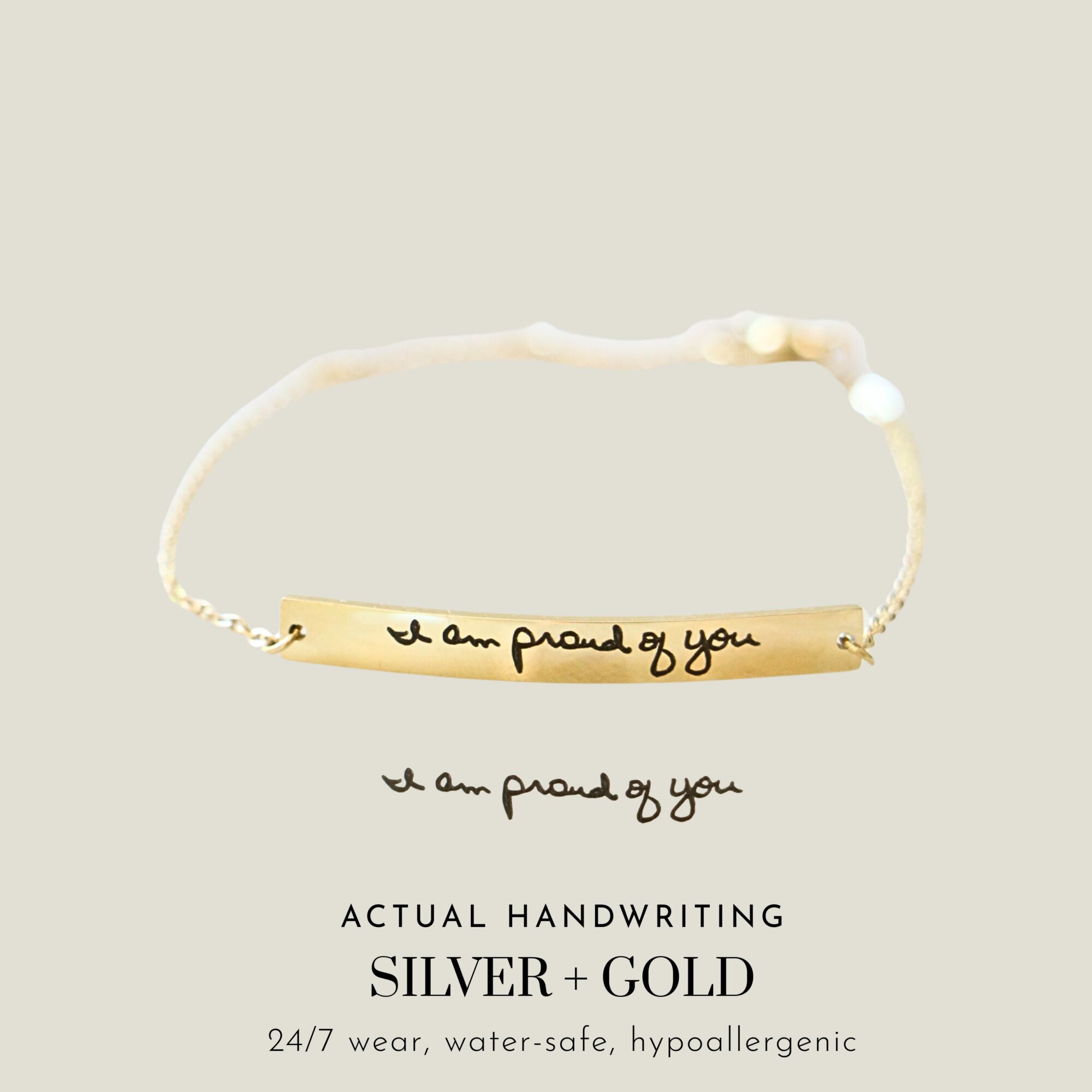 Bracelet with a gold plate engraved with 'I am proud of you' and a delicate chain. Text below repeats the message.