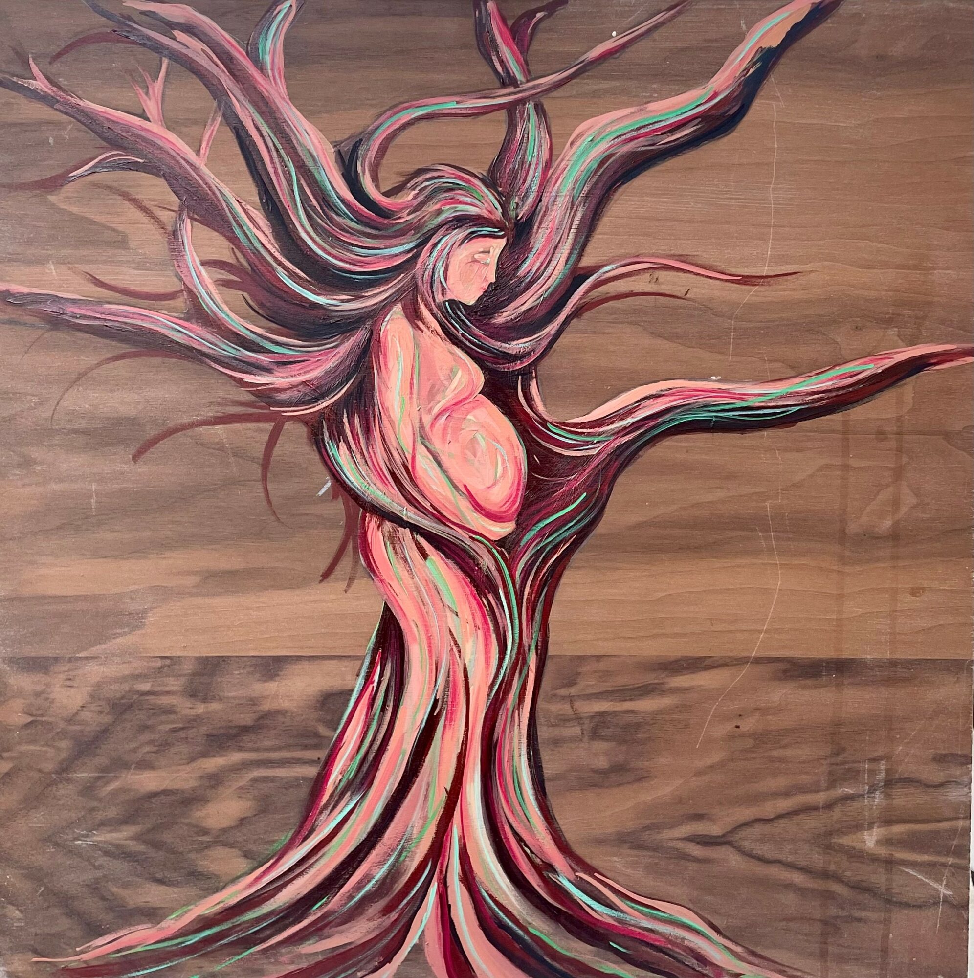 A painting of a pregnant woman with flowing hair blending into a tree, on a wooden background.