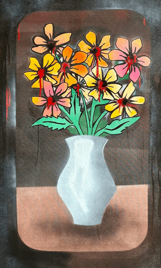 Colorful flowers in a white vase on a table, with a dark background.