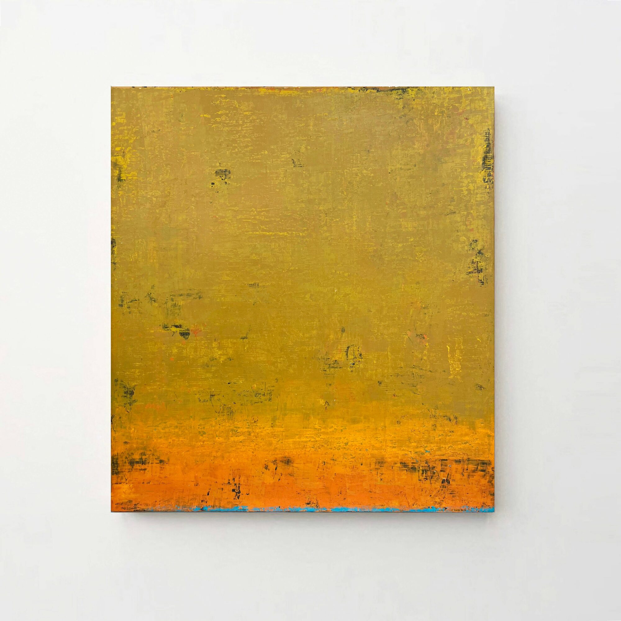 Abstract painting with yellow, orange, and blue colors on a square canvas, hung on a white wall.