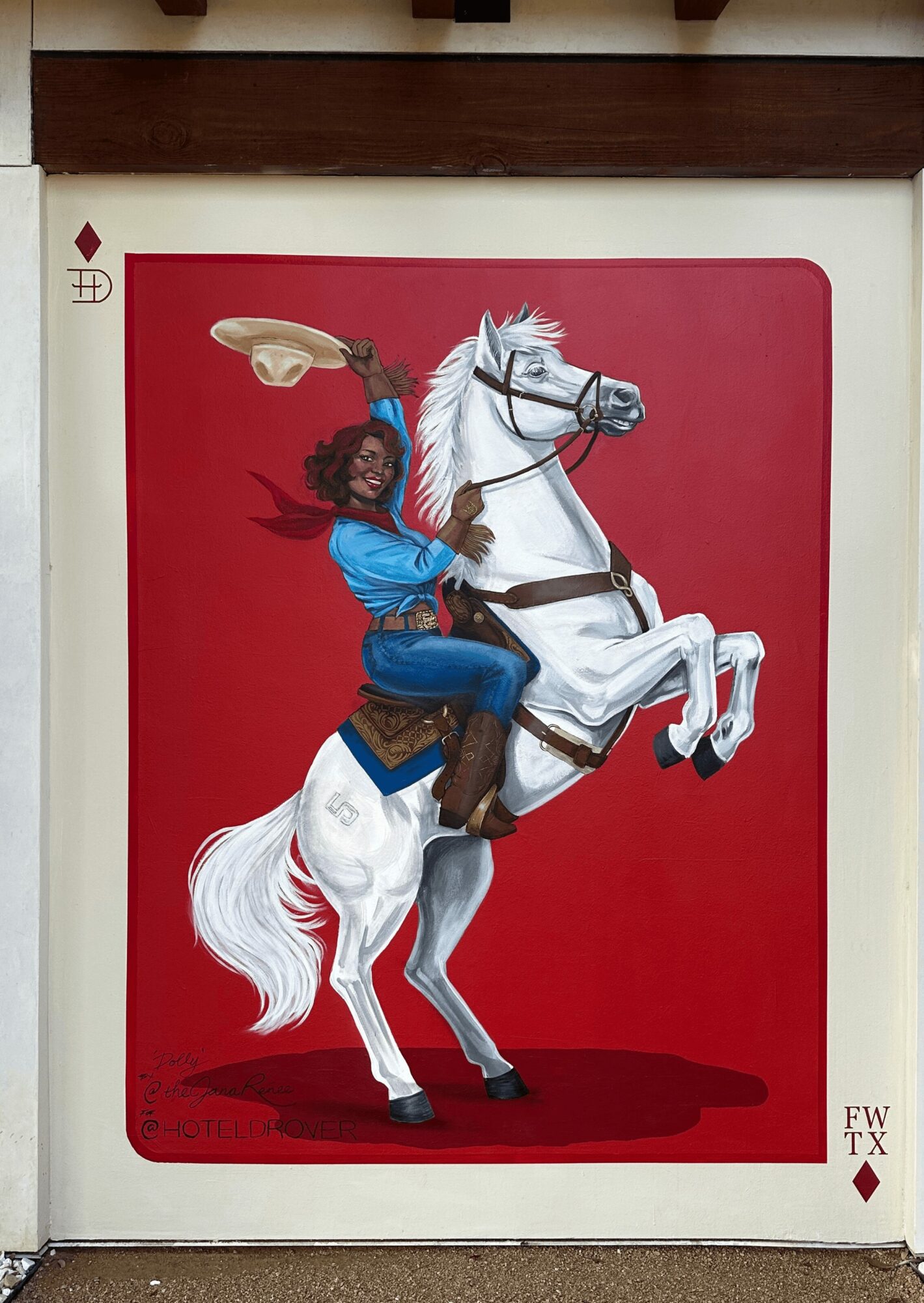 Person with dark curly hair riding a white horse, holding a feather, against a red background.