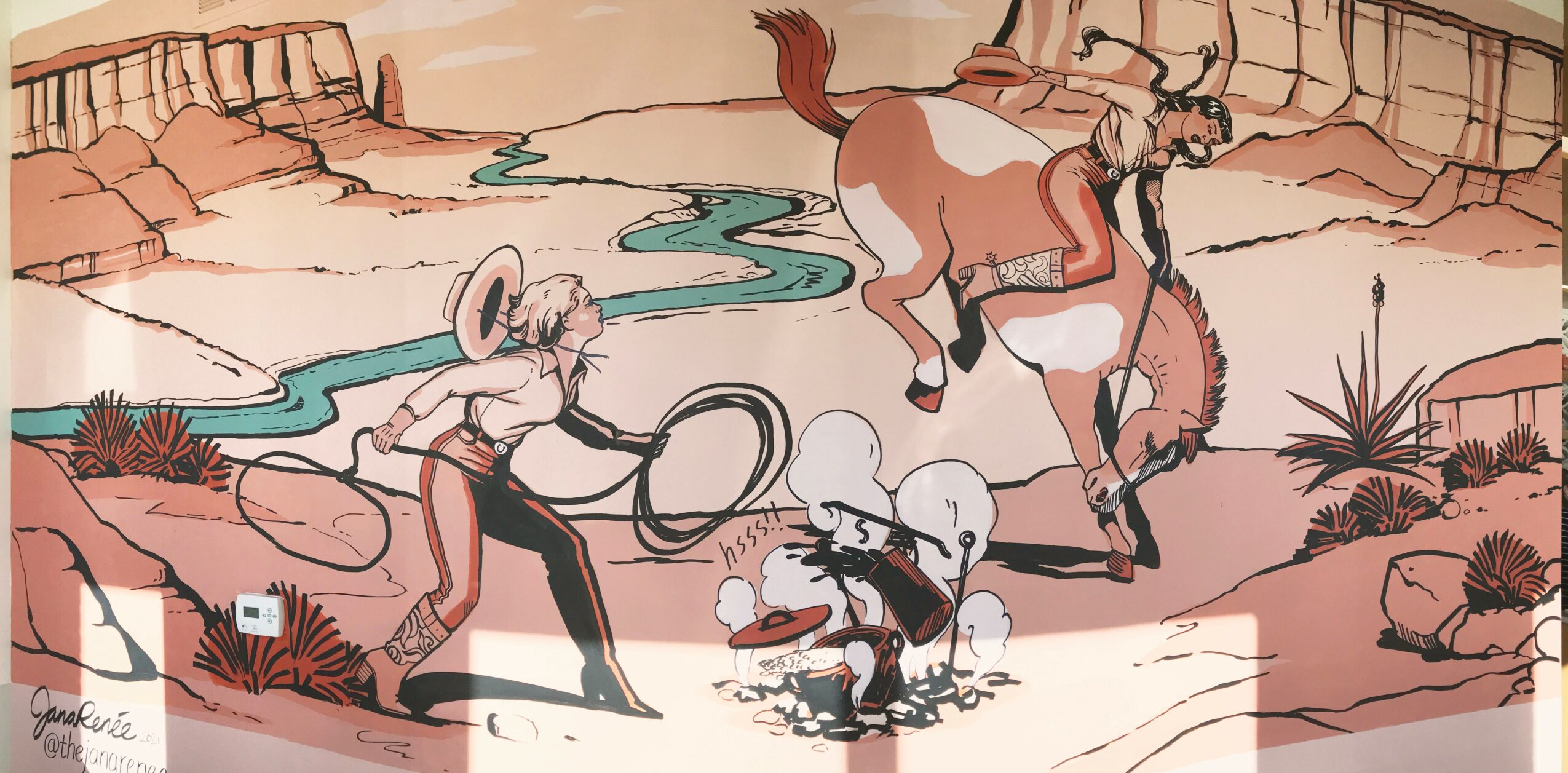 Two people riding a horse and a person sitting on the ground near a river in a desert landscape with cacti.