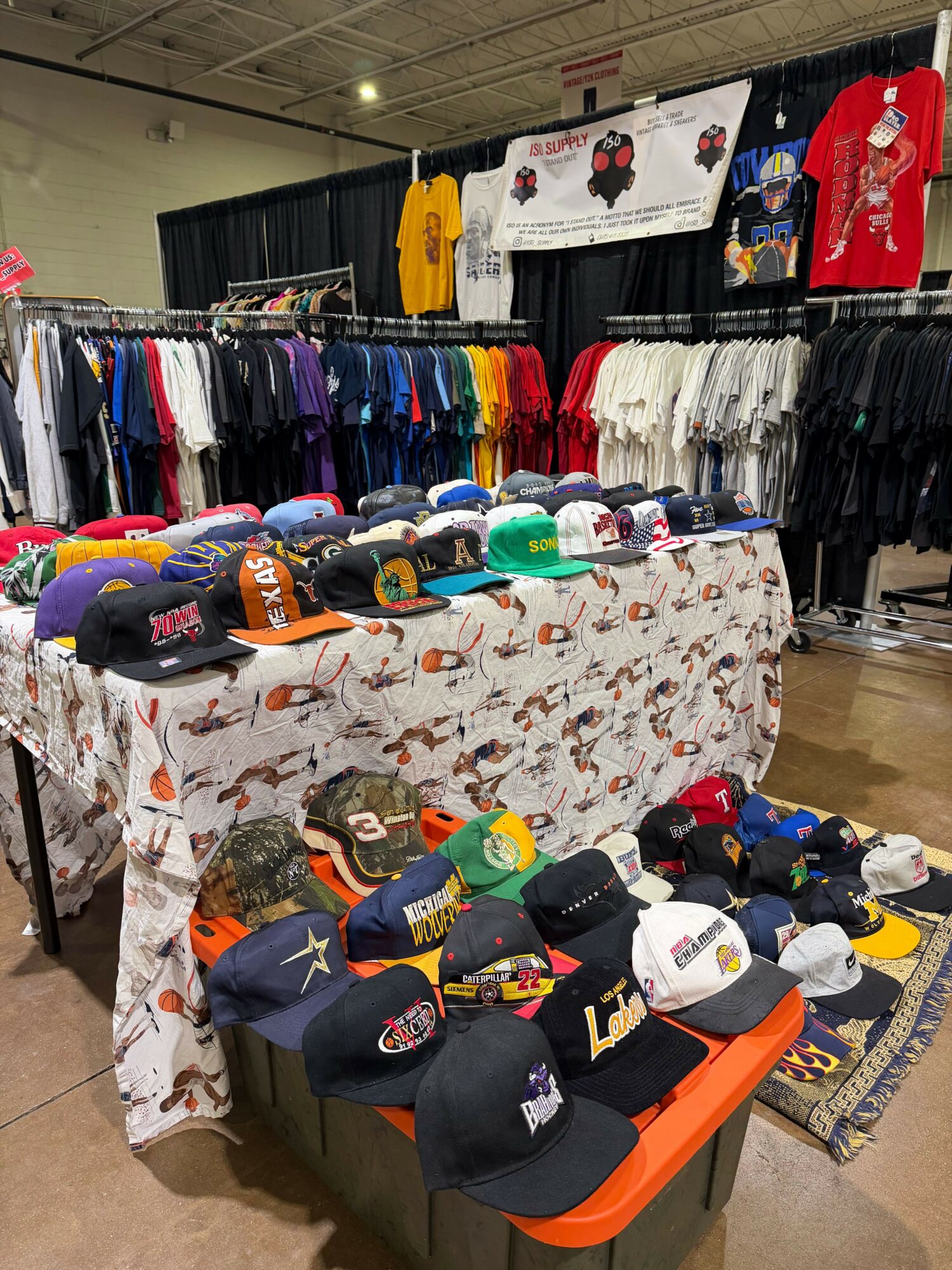 Table displays various socks and accessories in a store, with clothing racks in the background.