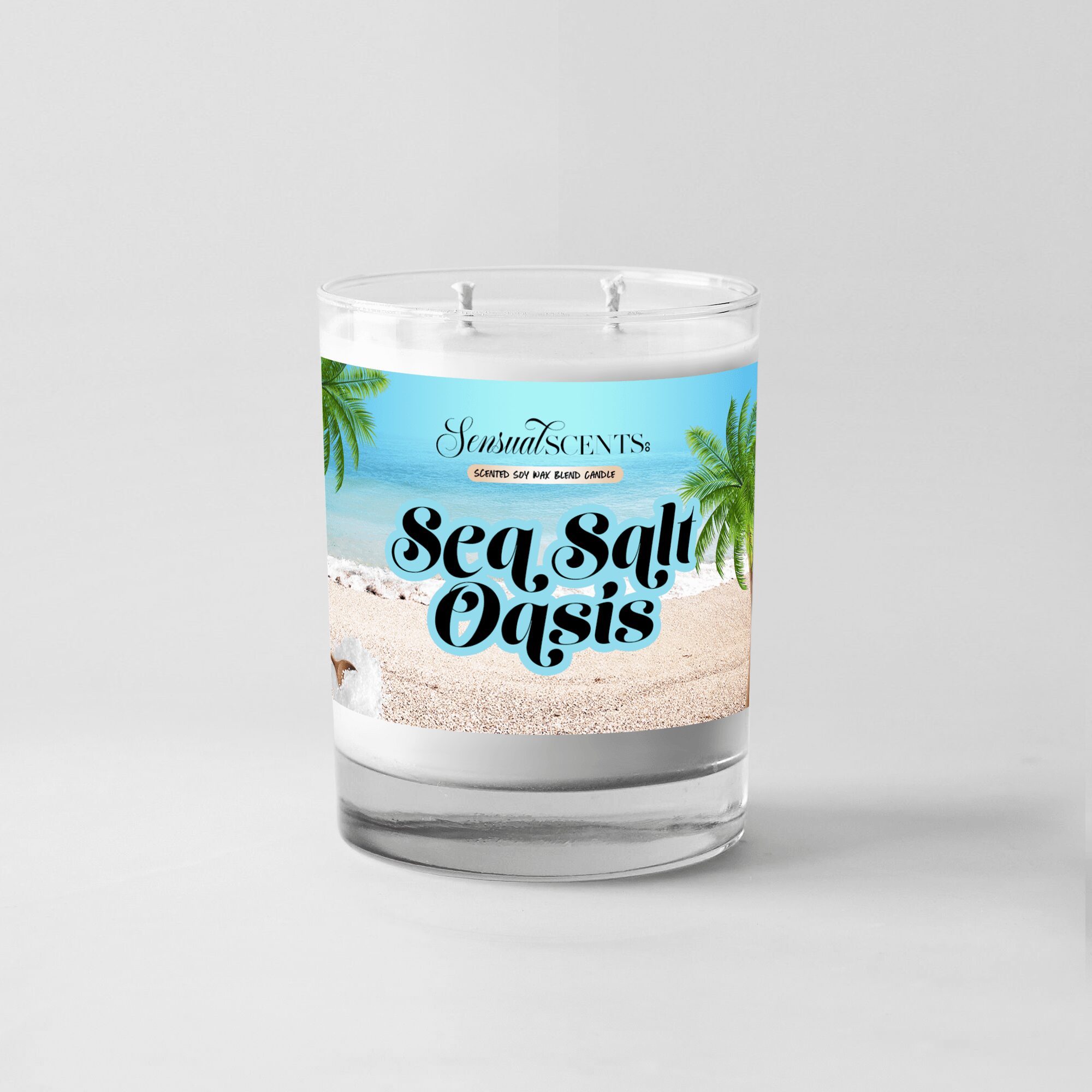 A scented candle in a glass jar with a beach scene label, palm trees, and the text 'Sea Salt Oasis'.