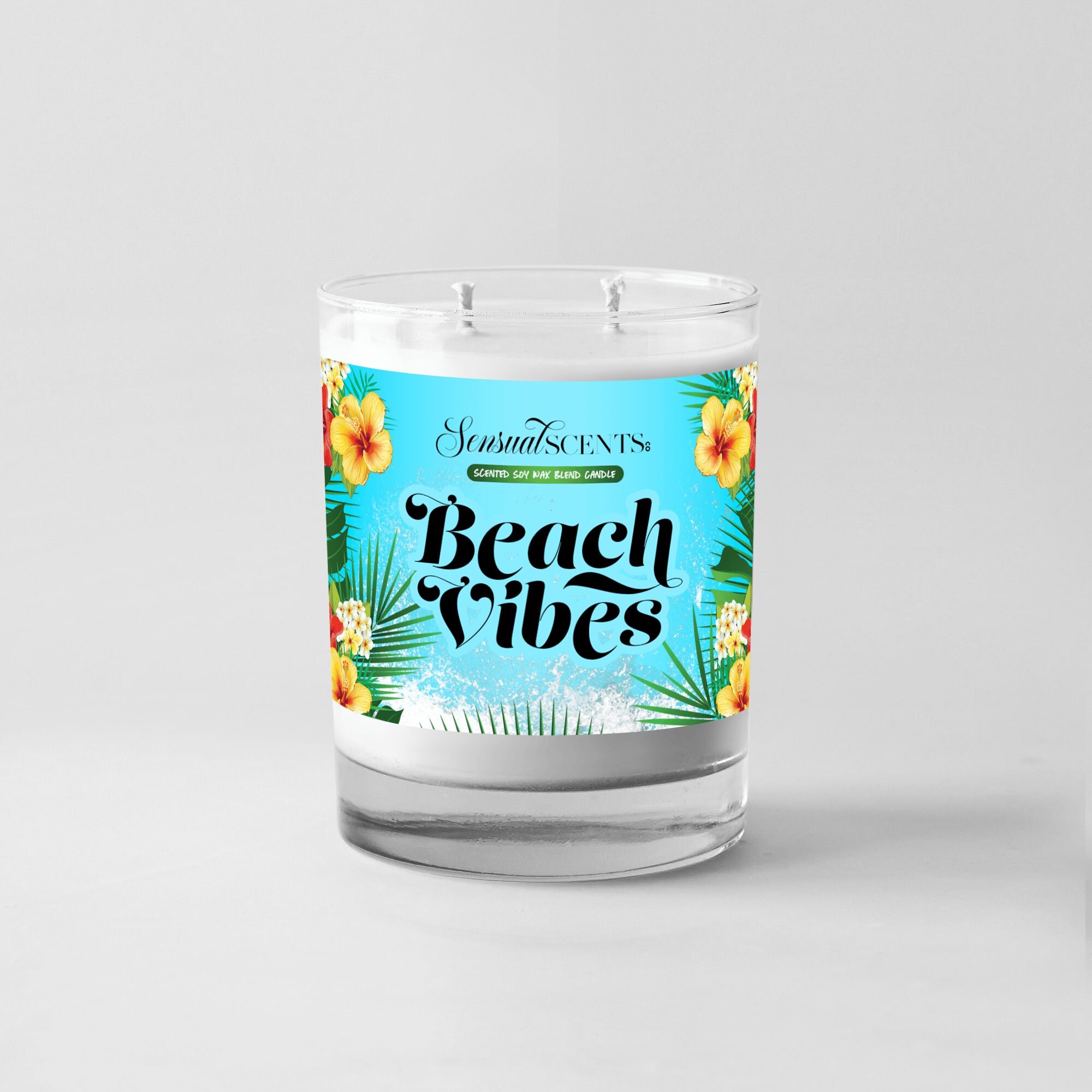 A candle with a label reading 'Beach Vibes' and tropical floral design, placed on a plain light background.