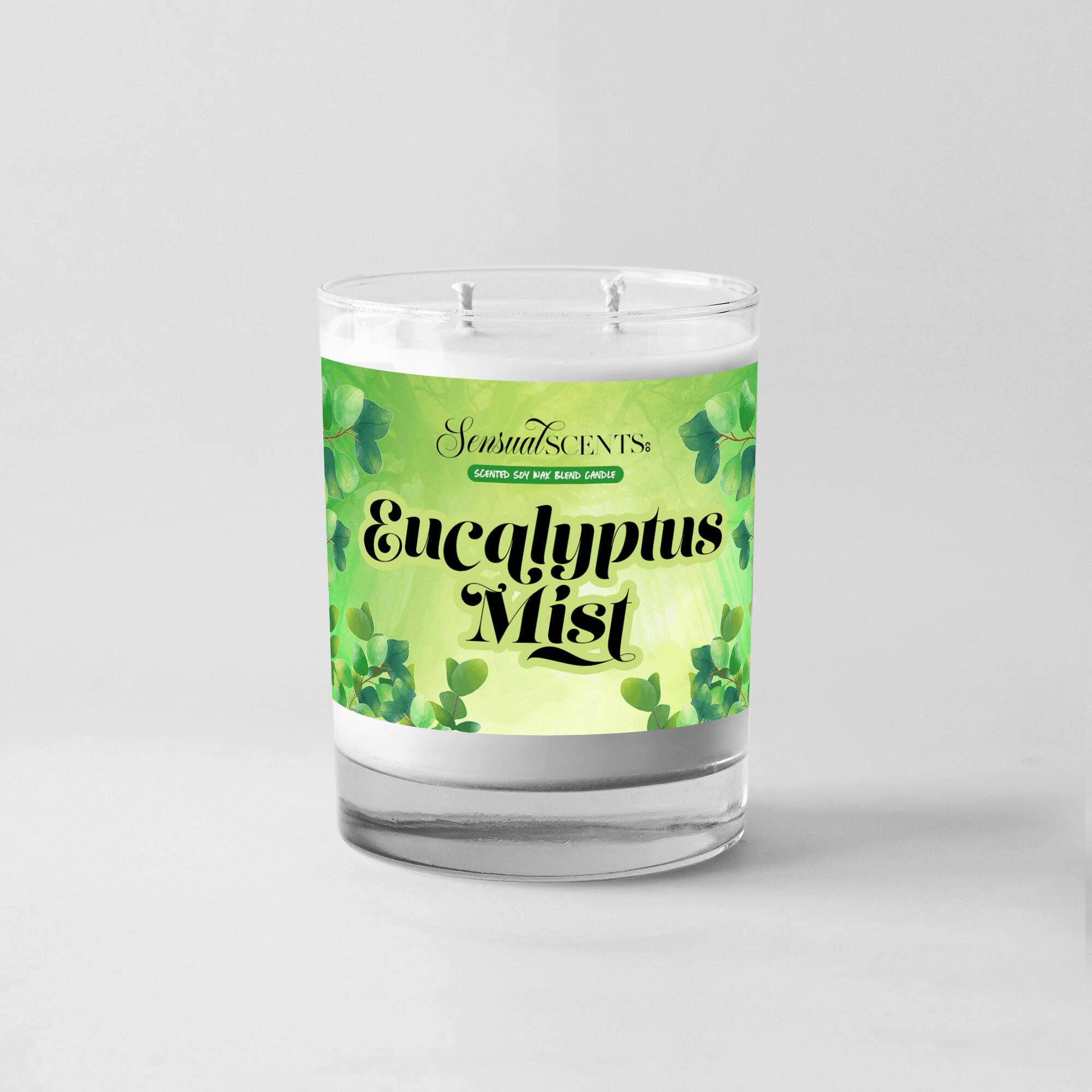 A candle labeled 'Eucalyptus Mist' with green leaves on a white background.