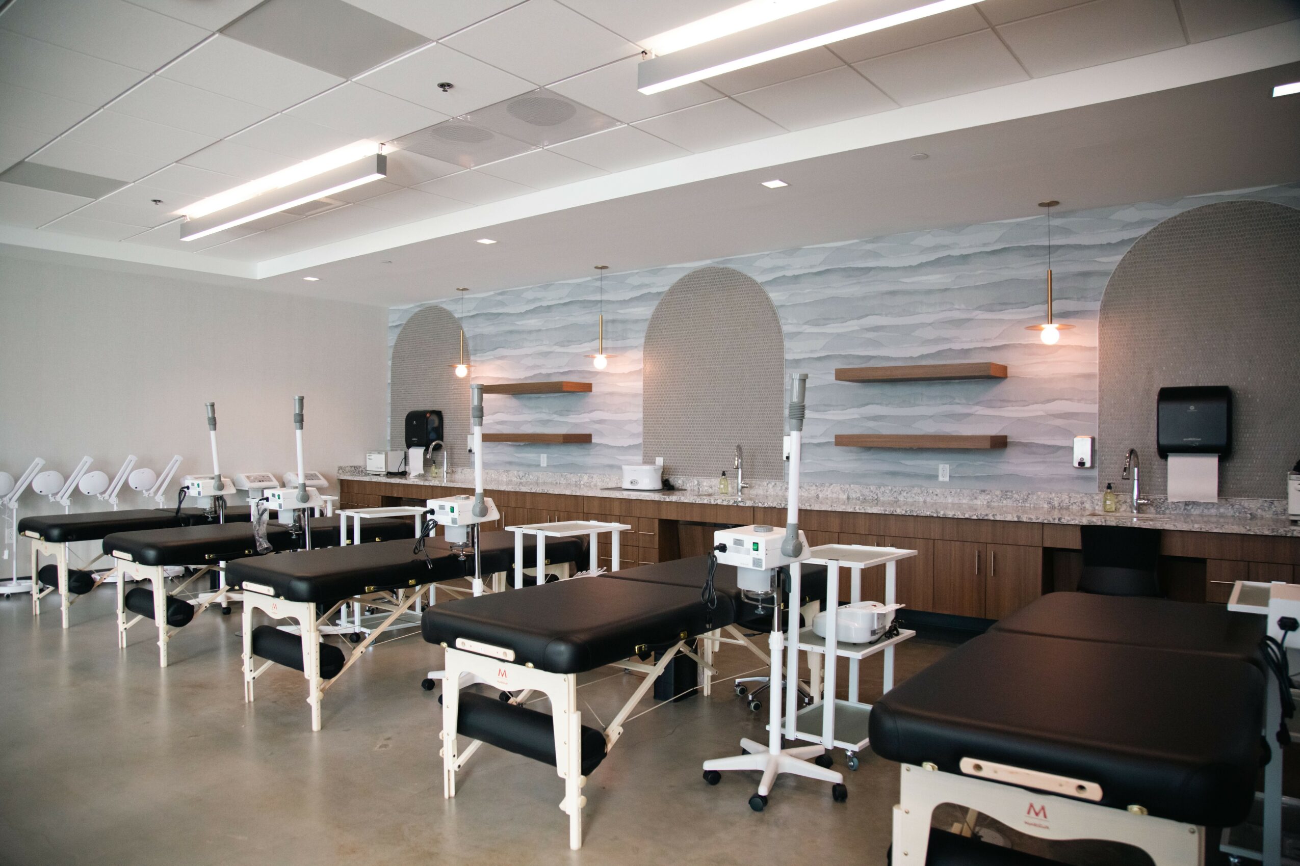 Hospital or clinic room with beds, medical equipment, and a clean, modern interior design.