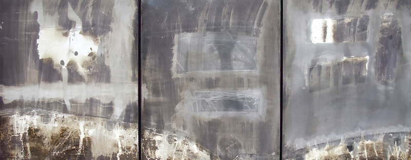 Close-up of a weathered, metallic surface with rust and discoloration.