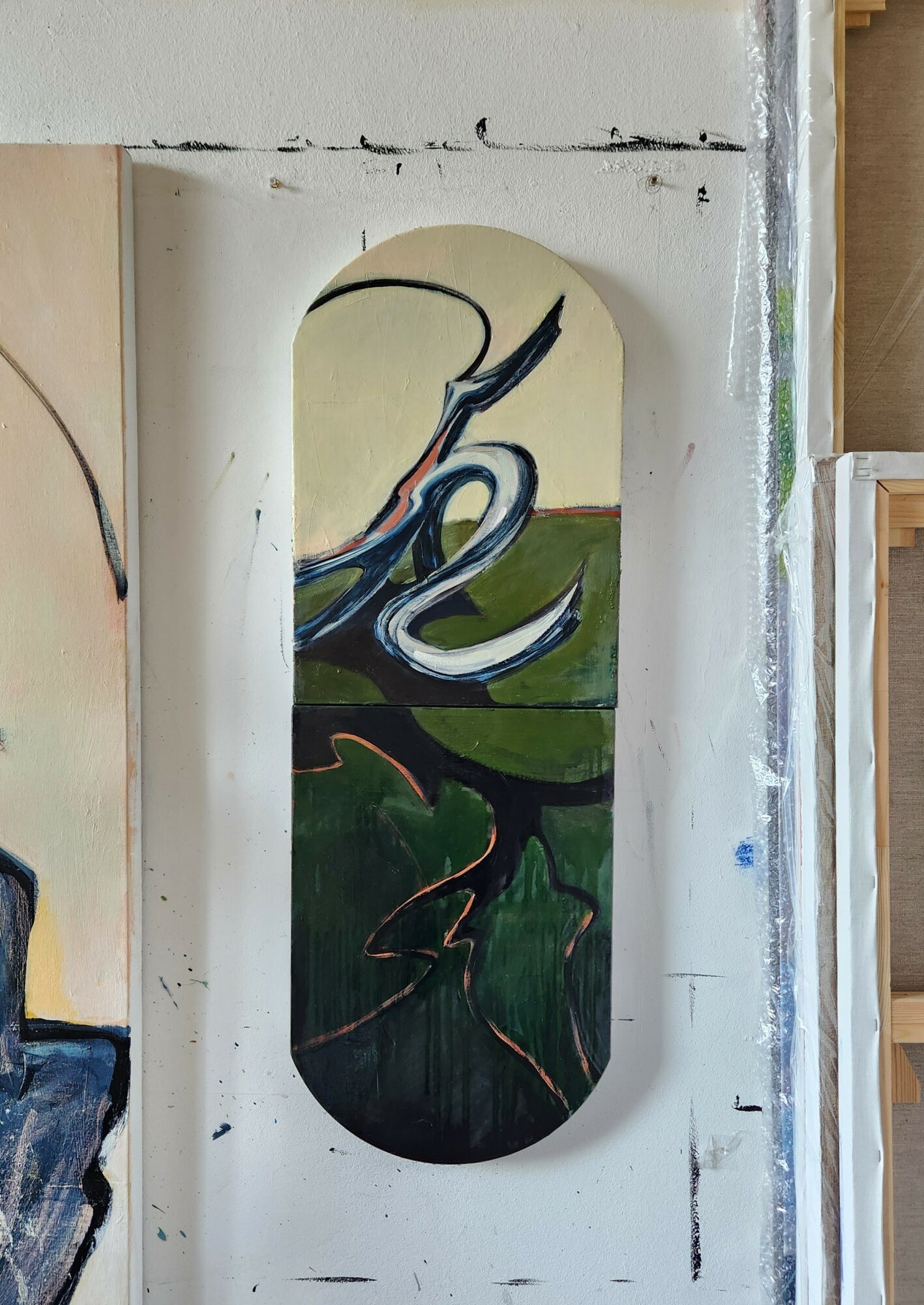 Vertical abstract painting with curved lines and colors, mounted on a white wall with visible paint marks.