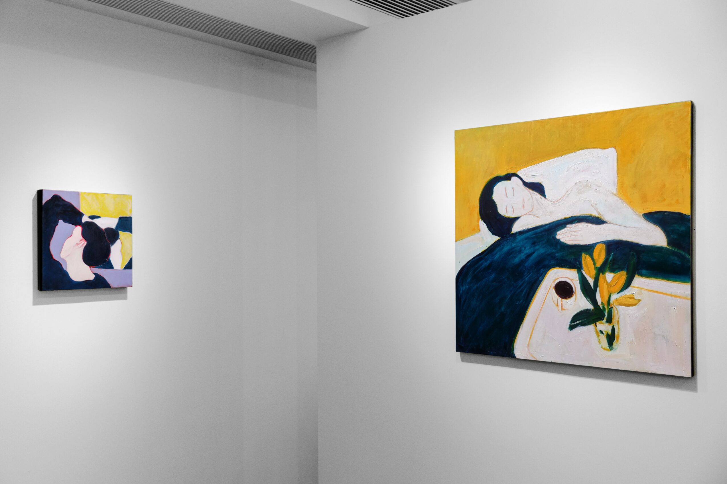 Two paintings on a white gallery wall, one larger with a woman and a bird, the other smaller with a woman and a bird.