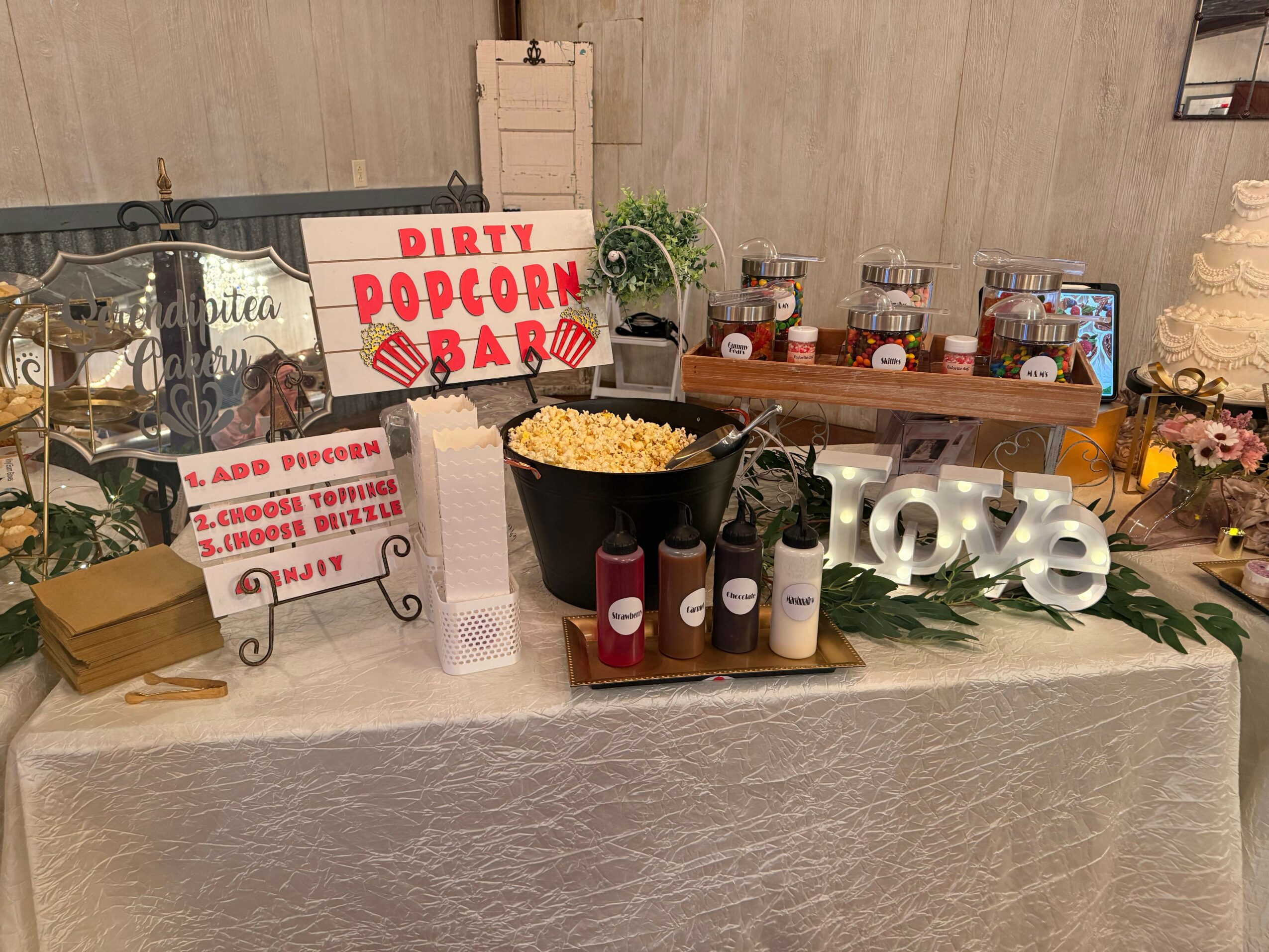 Display of bottles, a sign, and decorative items on a table, viewed sideways. The image is rotated 90 degrees clockwise.