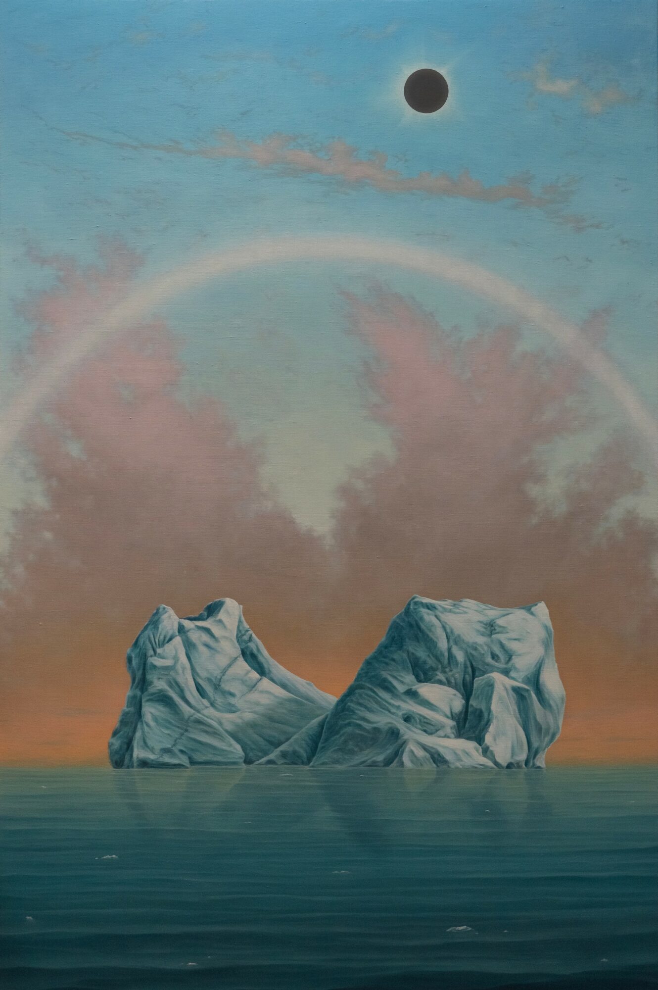 Two large icebergs floating in water under a sky with a dark eclipse and a rainbow-colored arc.
