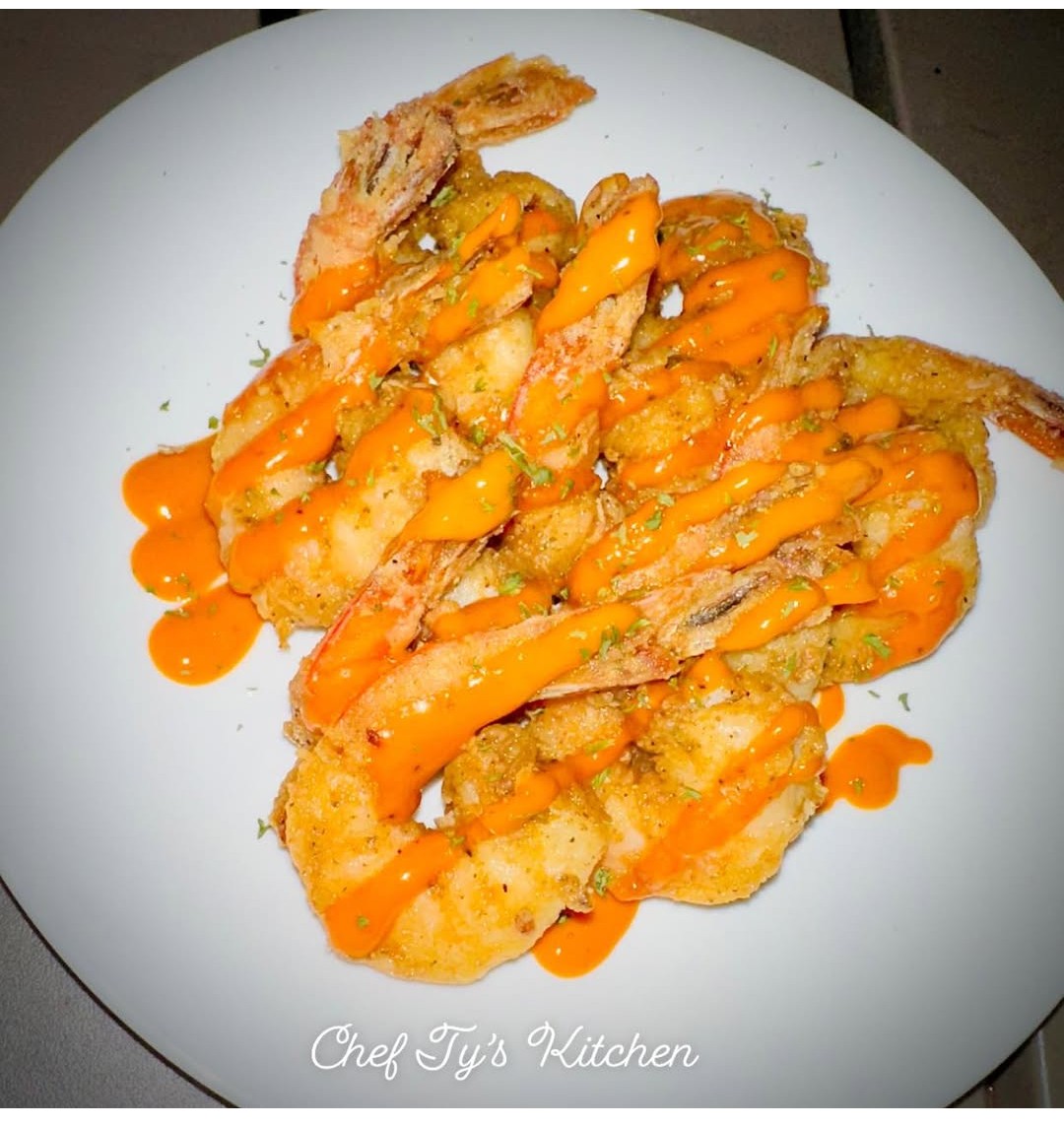 Fried shrimp topped with orange sauce on a white plate, with text 'Chef Tys Kitchen' at the bottom.