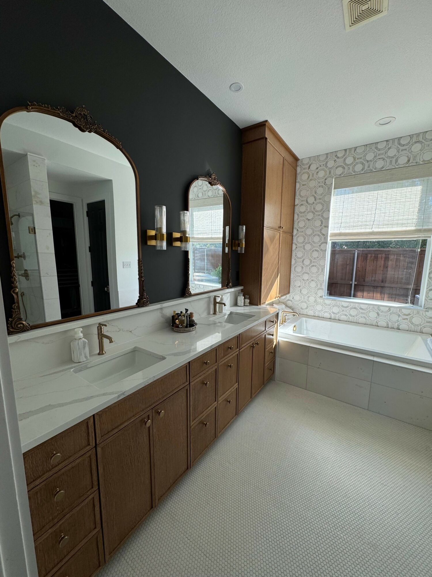 Bathroom with mirror, sink, wooden cabinets, and window, viewed from a rotated perspective.