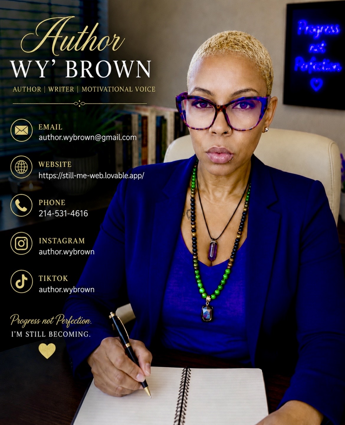 Woman with short blonde hair and glasses, wearing a blue blazer, sitting at a desk with a notebook and pen.