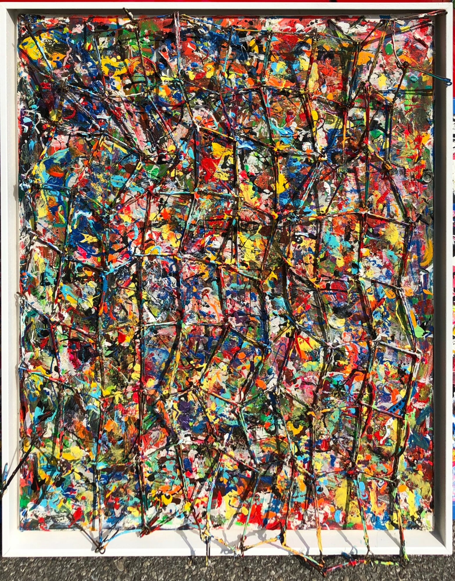 Colorful abstract painting with splashes and drips of paint, black lines, and a white frame.