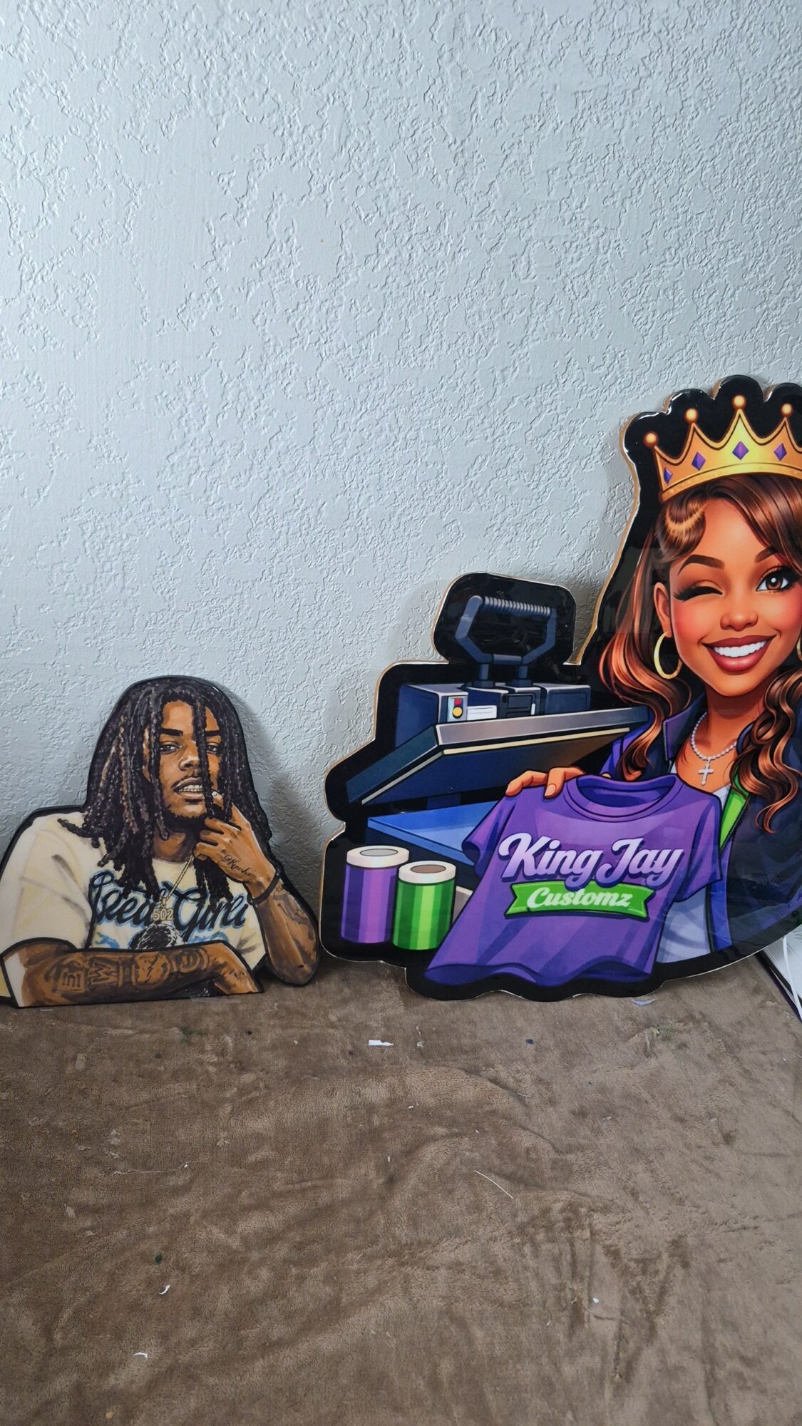 Collection of items including a bag with a person, a crown, and a box with colorful objects on a surface.